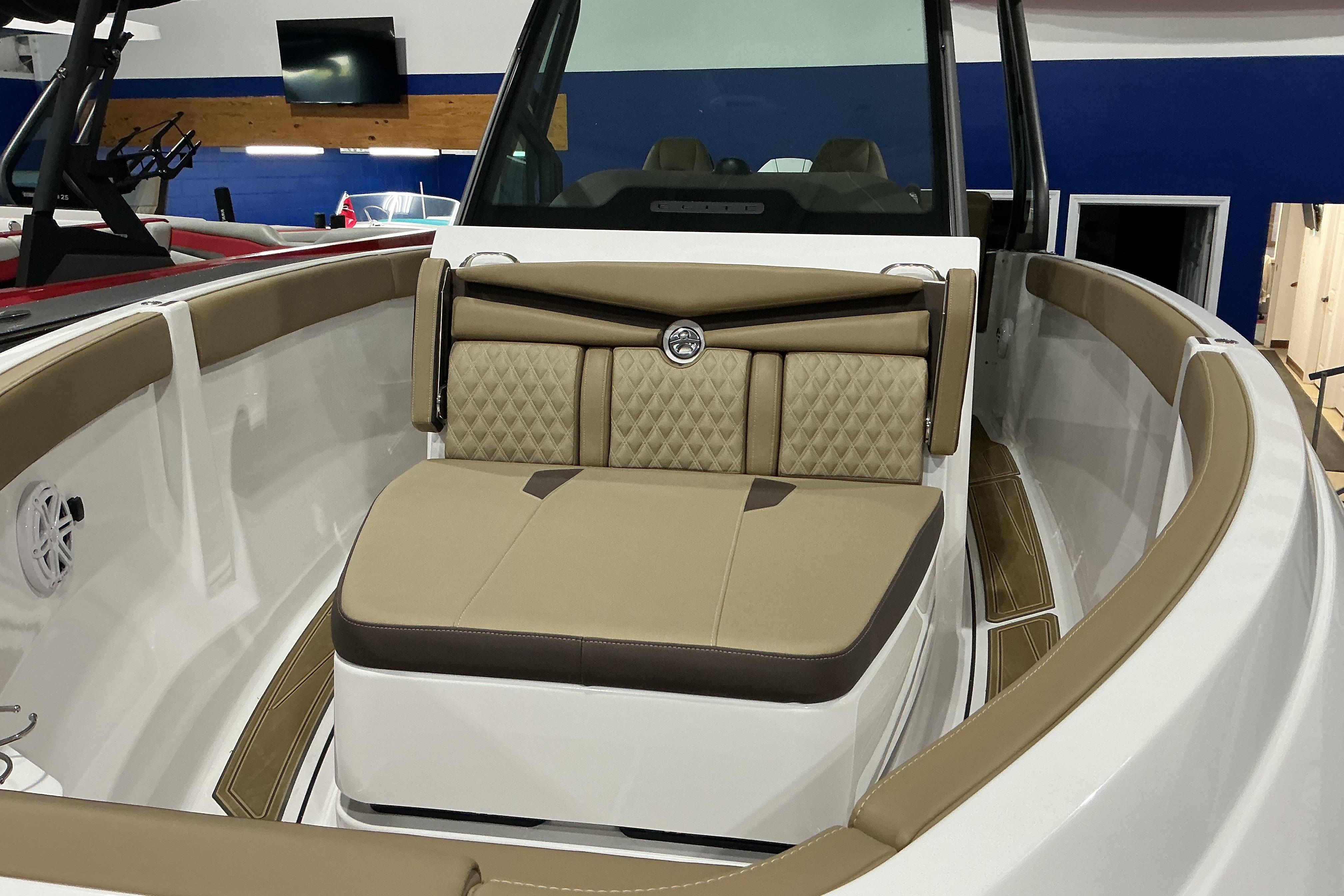 Luxurious interior of 2026 Monterey Elite 25 OB boat with tan seating and modern design.
