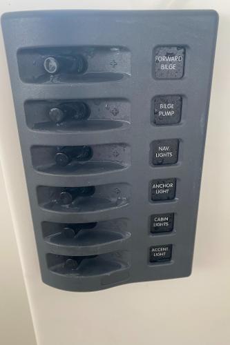 Switch panel with various boat controls, including bilge pump and navigation lights.