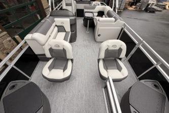 2026 Sun Tracker Fishin' Barge 20 DLX interior with seating and fishing amenities.