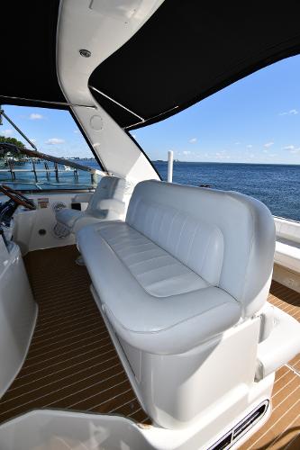 1997 Sea Ray 400 Sundancer yacht interior with white seating and ocean view.