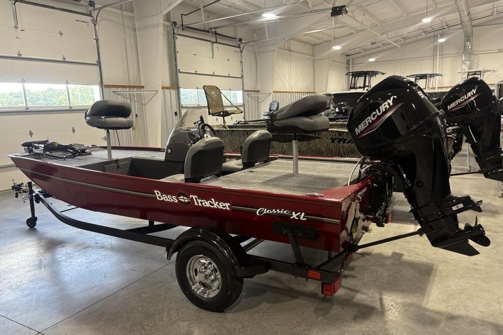 2026 Tracker Bass Tracker Classic XL boat in showroom with Mercury outboard motor.