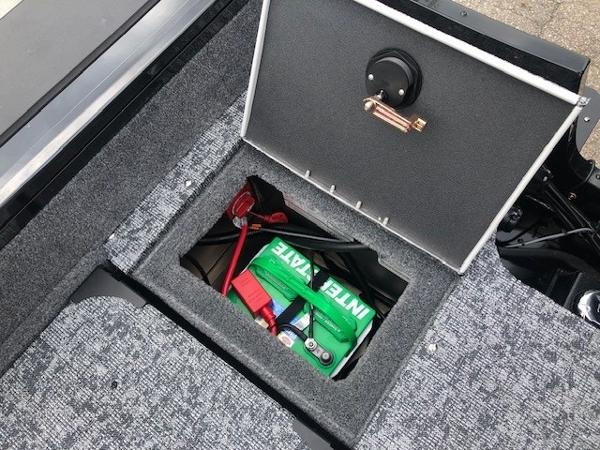 2025 Tracker Targa V18 Combo boat storage compartment with battery.