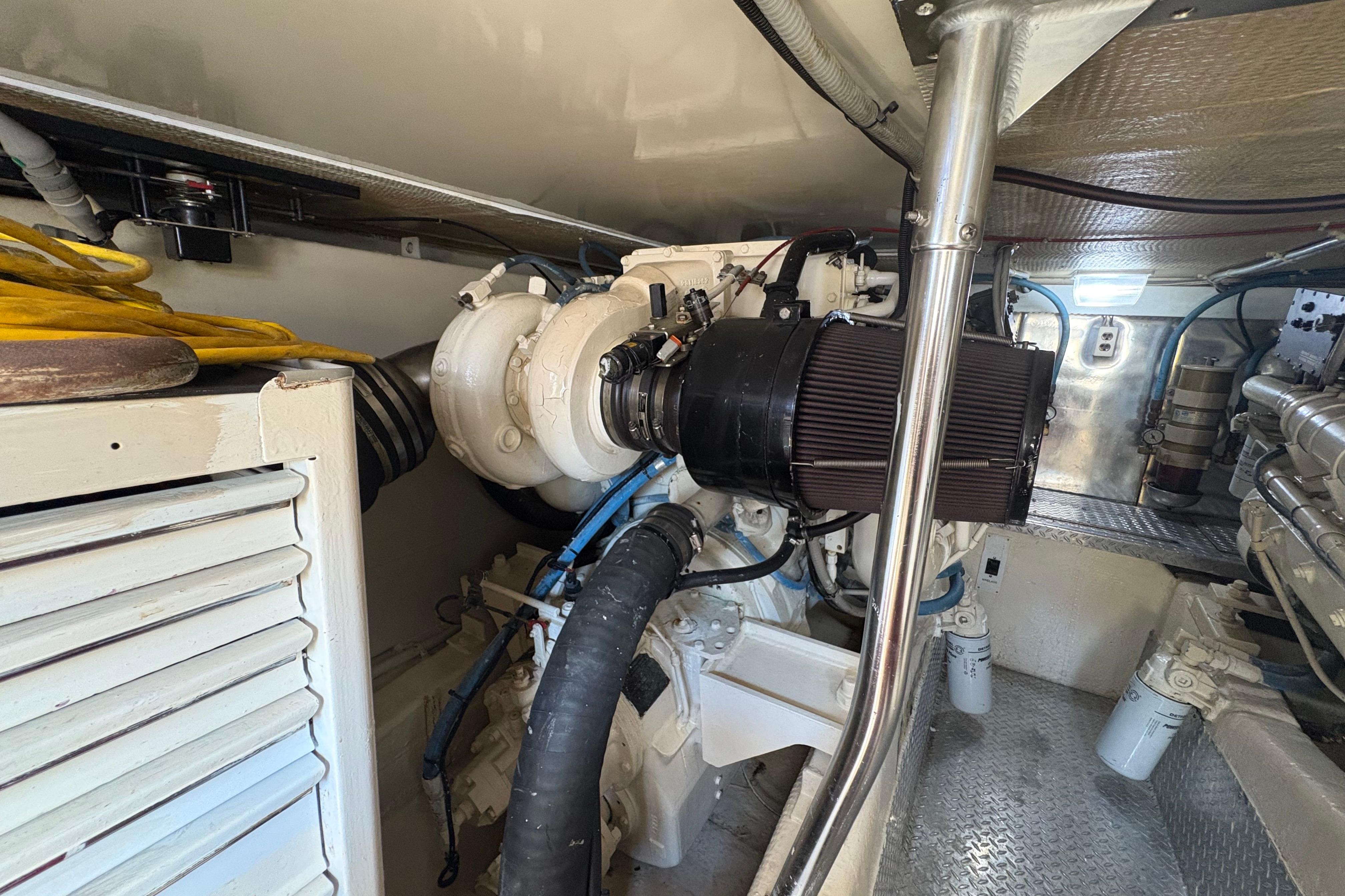 Engine room of a 1996 Ocean Yachts 48 Super Sport, showcasing mechanical components.