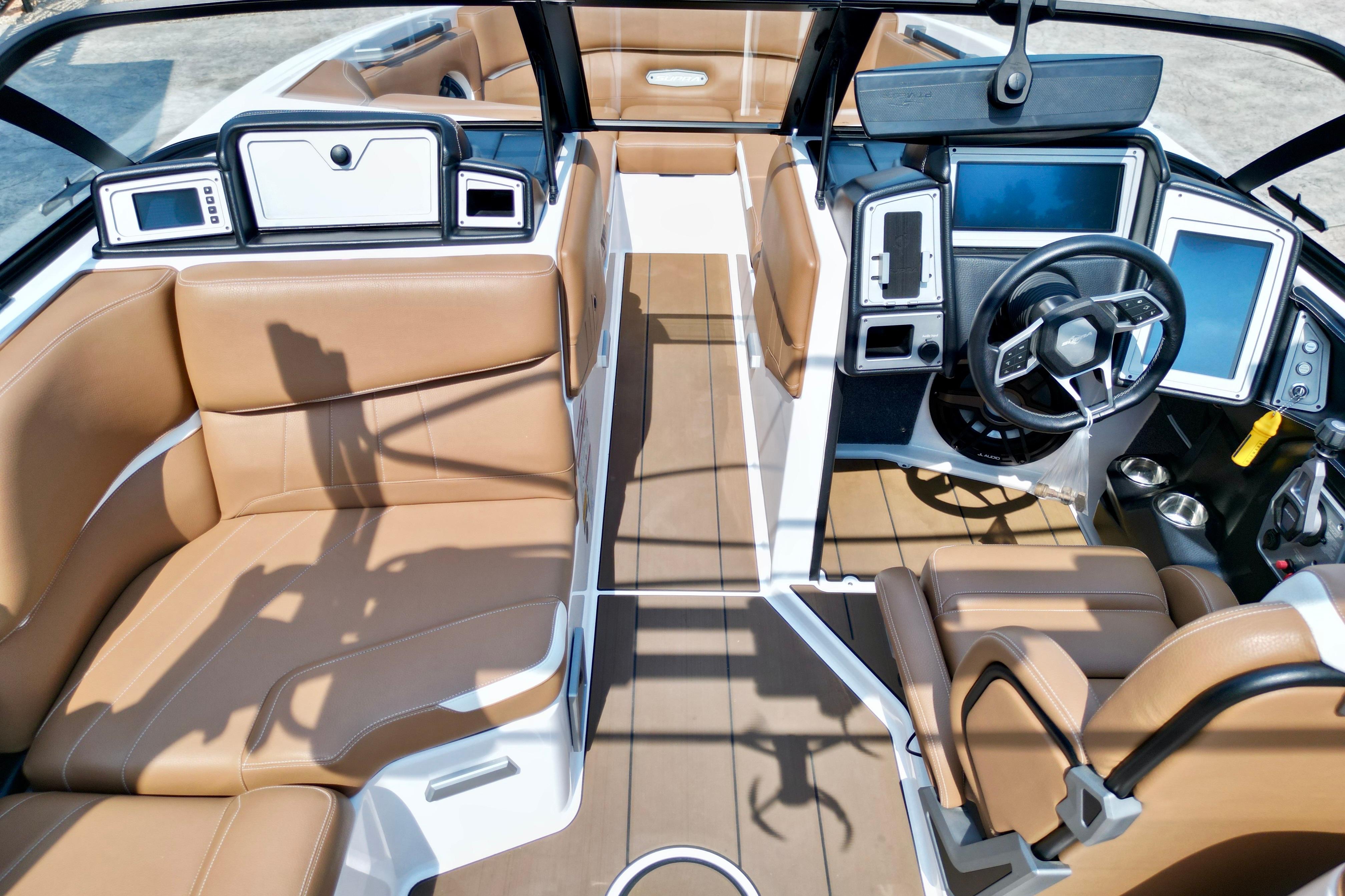 2021 Supra SE boat interior with luxurious tan seating and modern dashboard design.