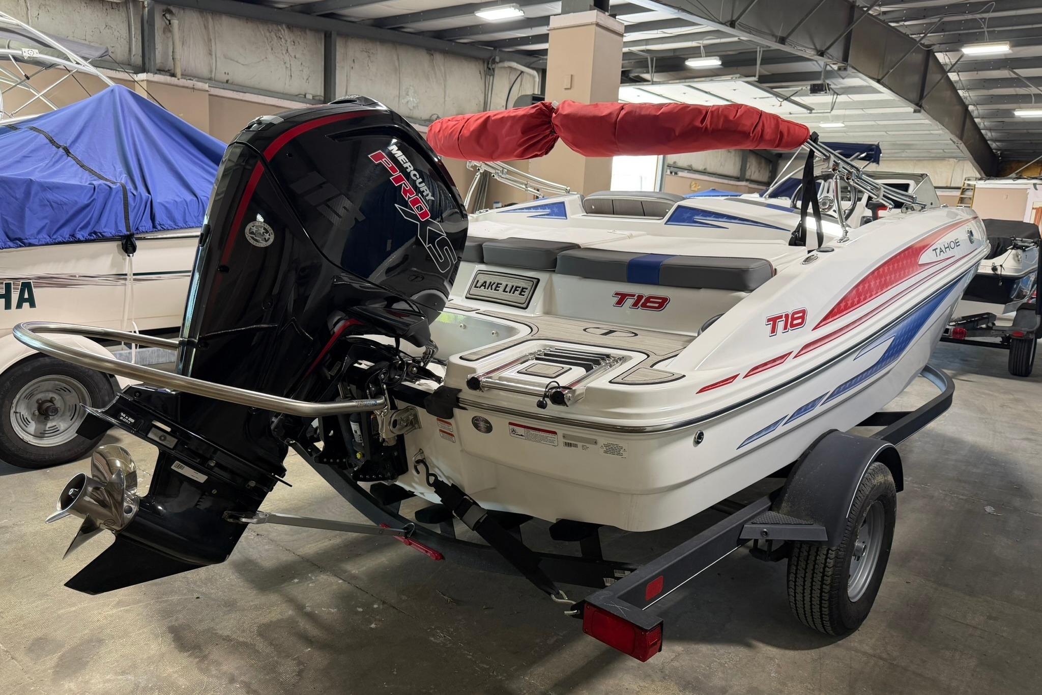 2024 Tahoe T18 boat with Mercury Pro XS engine in indoor storage.