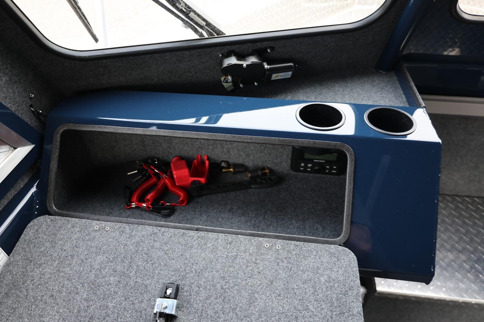 Interior storage compartment of 2026 Thunder Jet 24 Alexis Pro boat with cup holders.