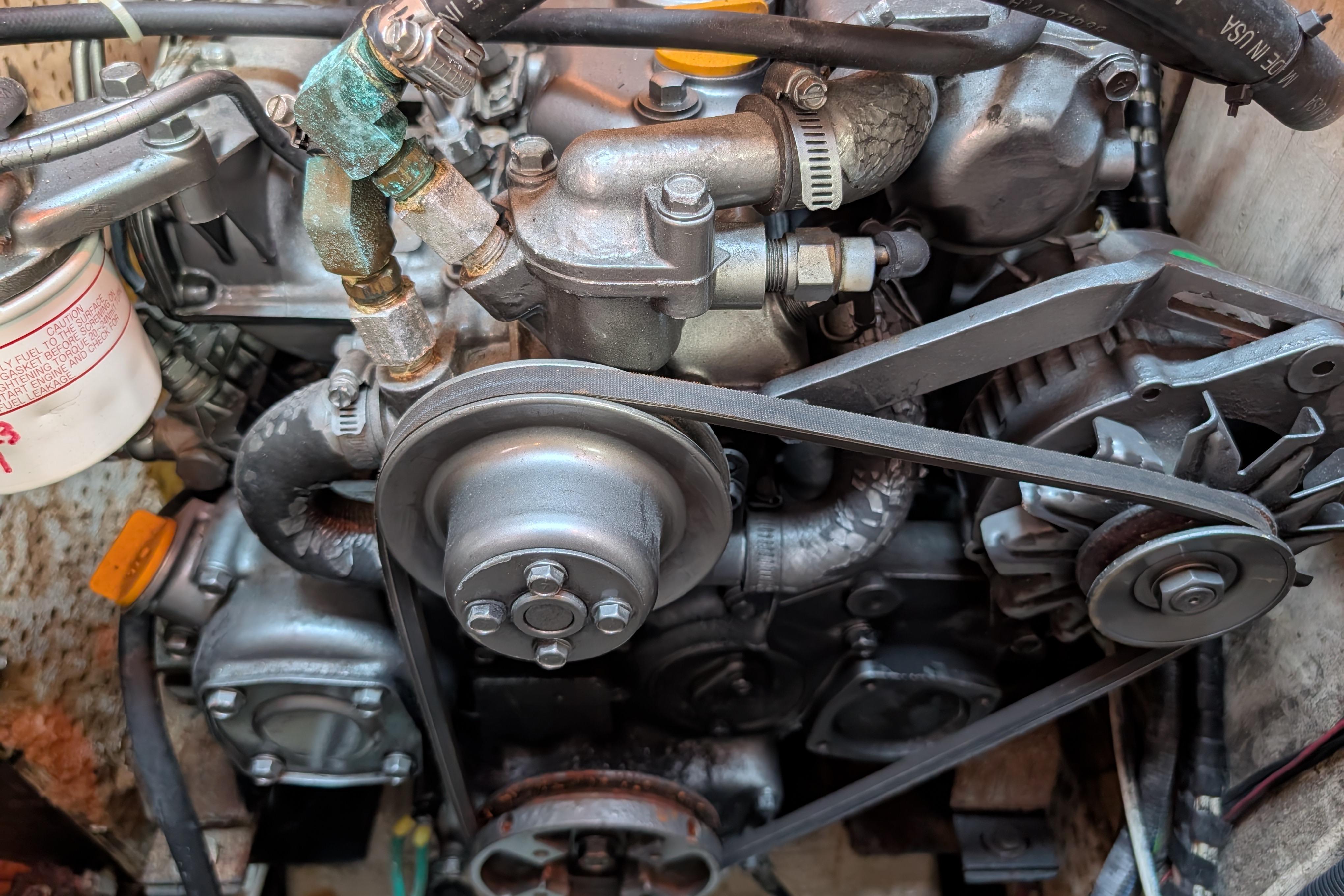 Close-up of a 1983 Robert Perry 41 engine with visible belts and components.