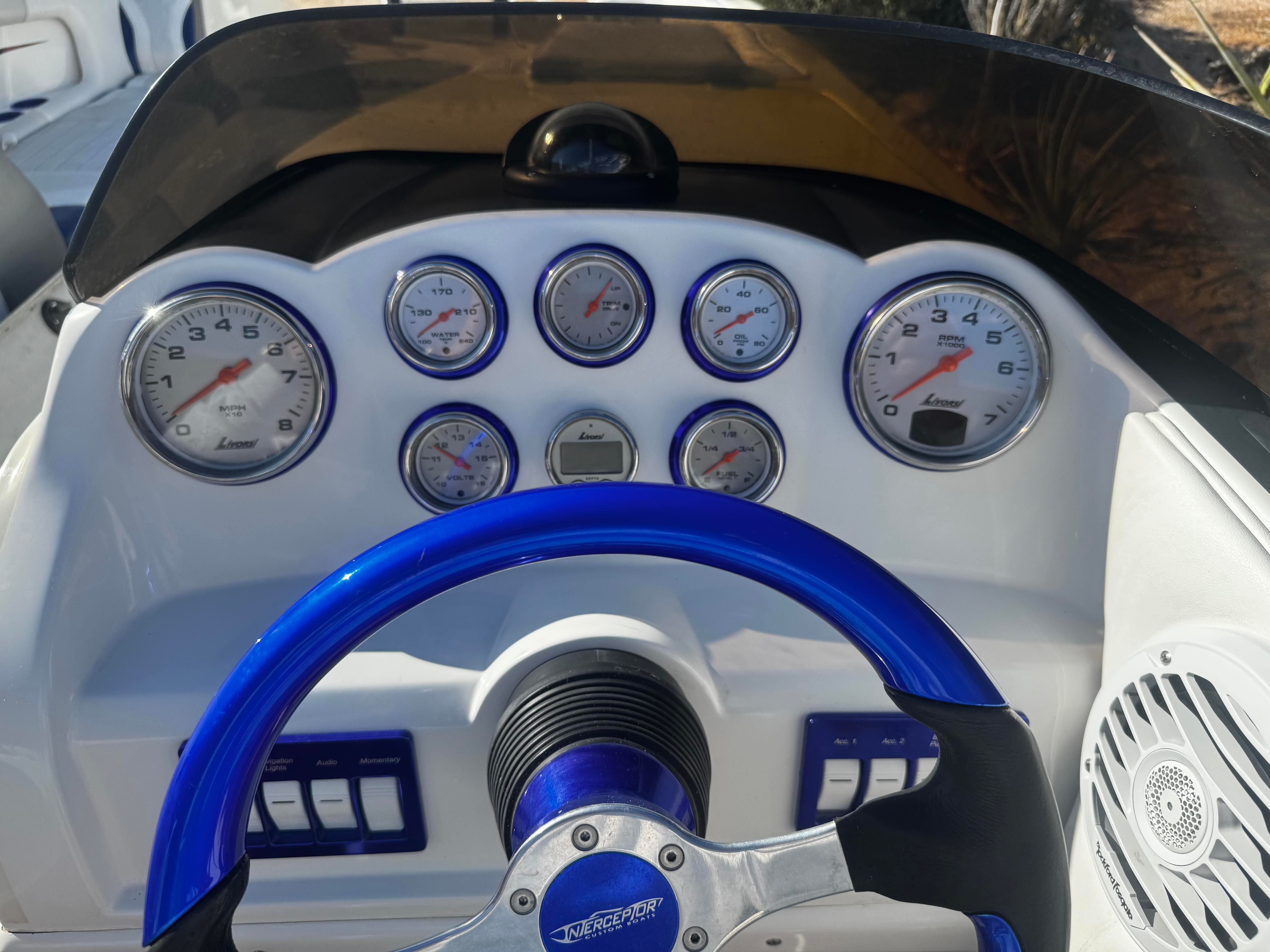 Dashboard of a 2016 Interceptor CoolCat with blue steering wheel trim and multiple gauges.