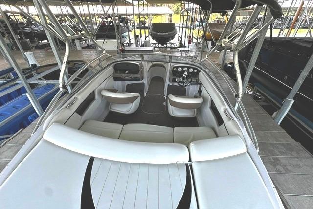 2007 Four Winns 200 Horizon boat interior with seating and dashboard in a marina.