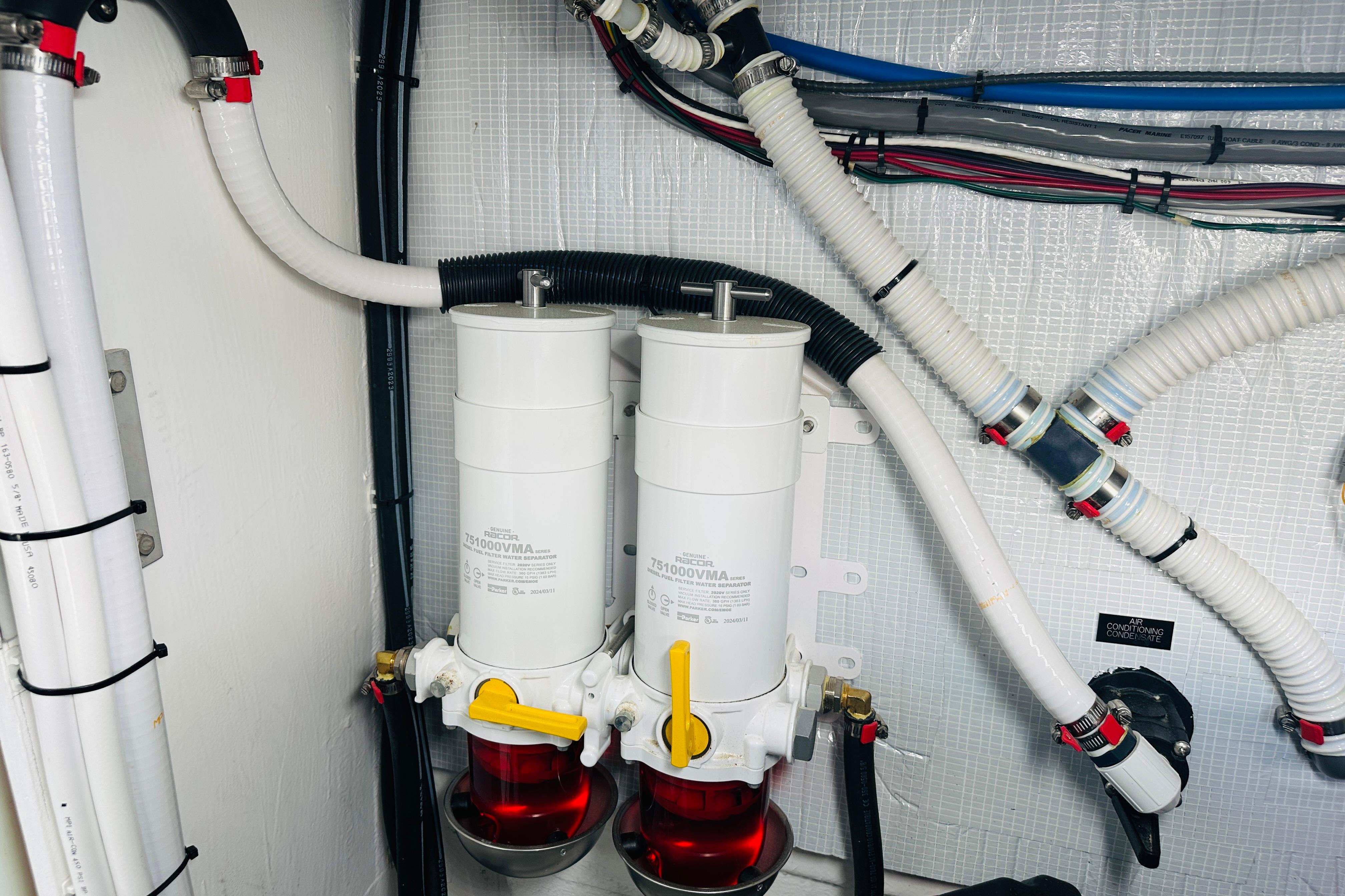 Engine room of 2025 Sabre 48 Salon Express with fuel filters and hoses.