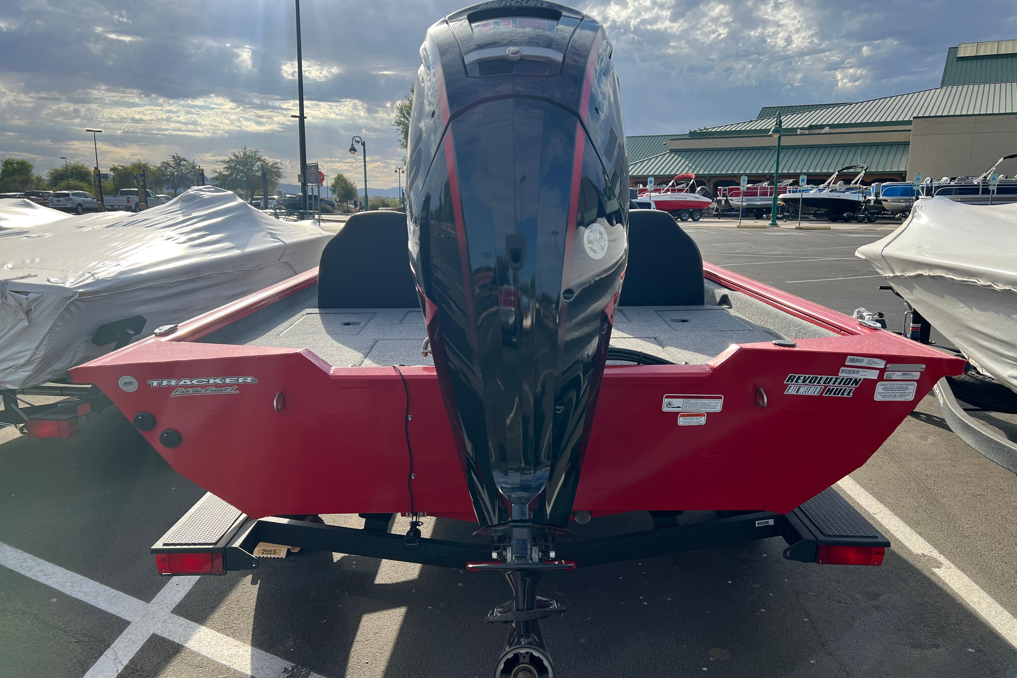 2026 Tracker Pro Team 190 boat with outboard motor in a parking lot.