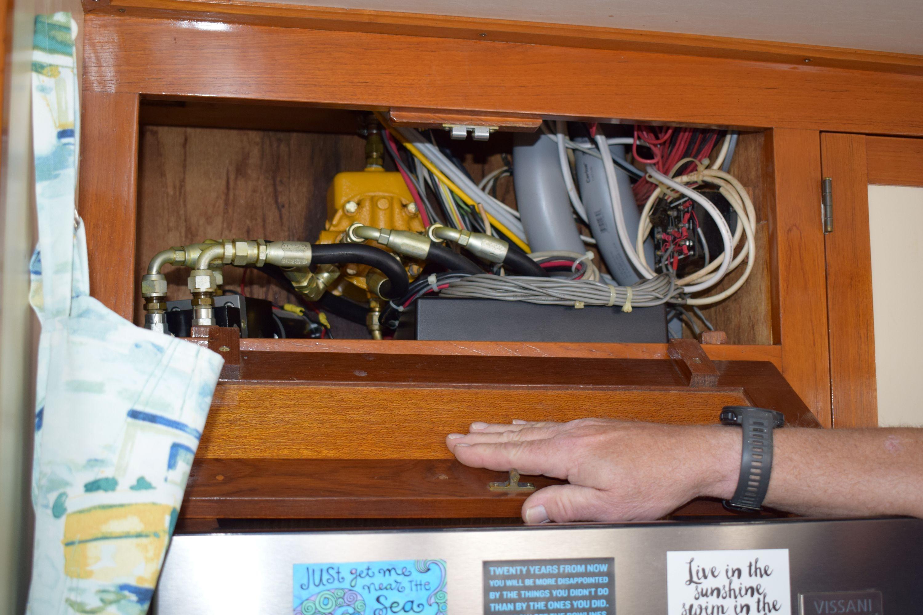 Electrical wiring and components inside a 1980 Cheoy Lee 52 Motorsailer cabinet.