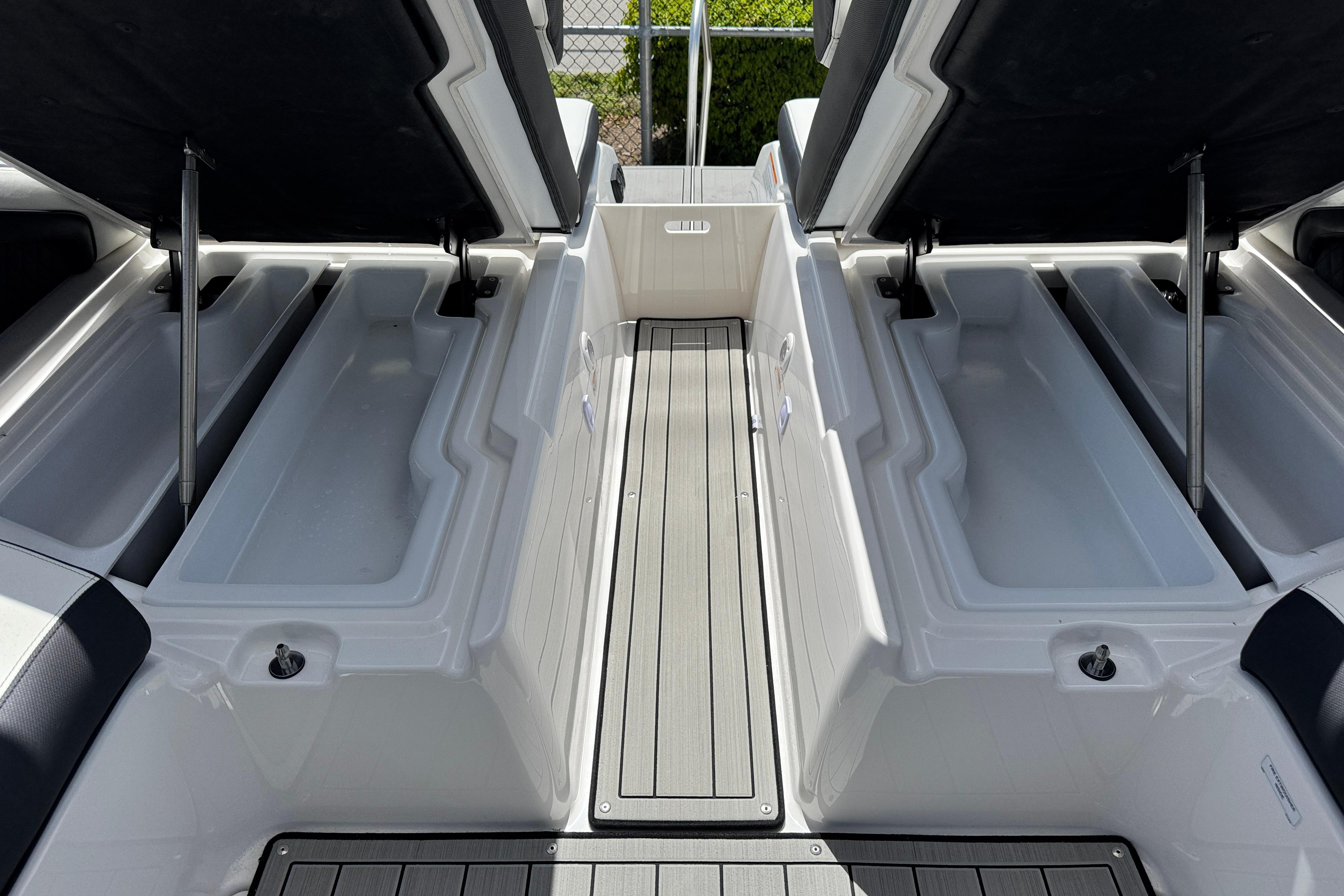 Open storage compartments on 2026 Yamaha Boats 275SD, showcasing spacious interior design.