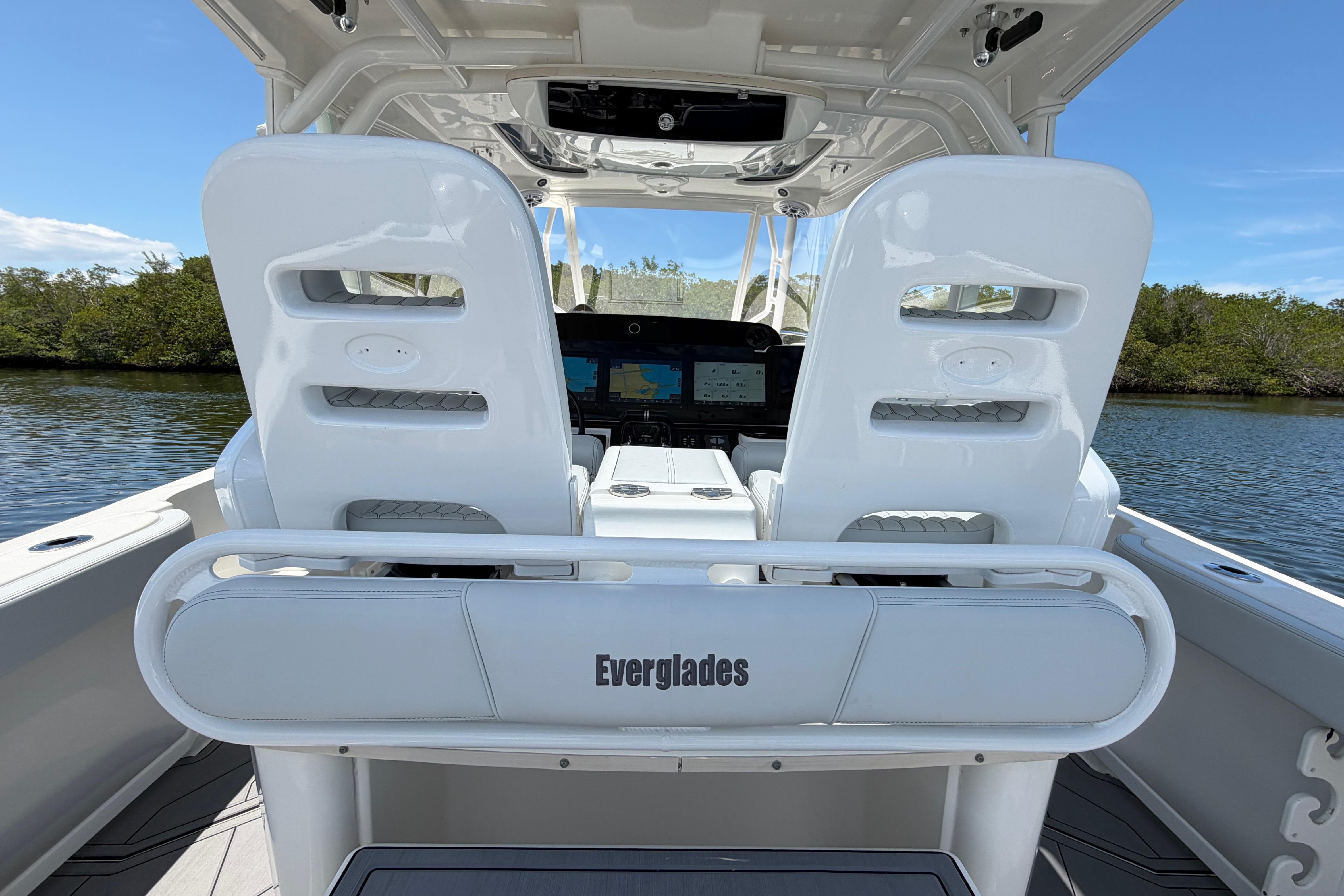 2009 Everglades 350LX boat interior with dual white seats and navigation console.