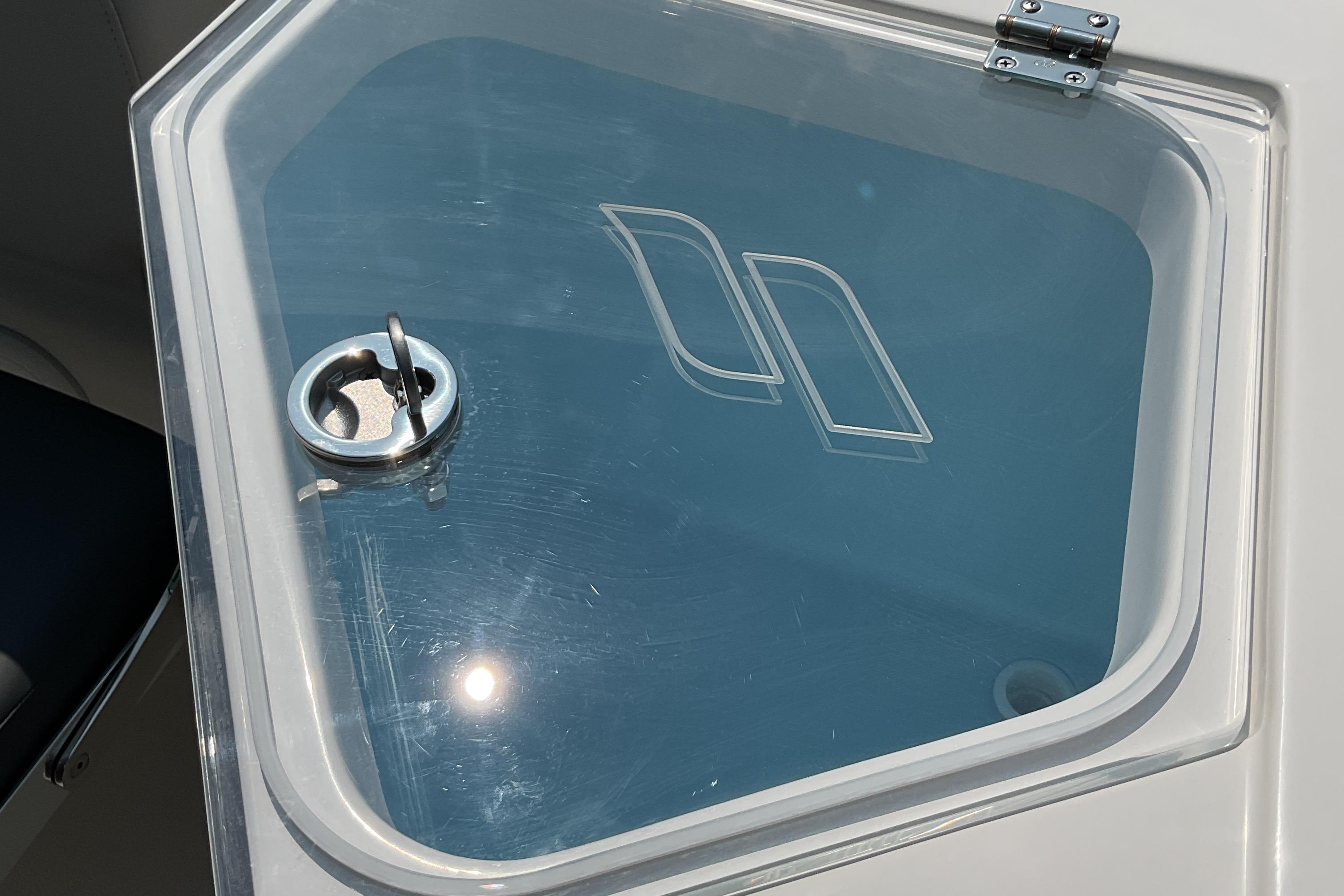 2026 Starcraft SVX 231 OB CC boat hatch with logo and latch in sunlight.