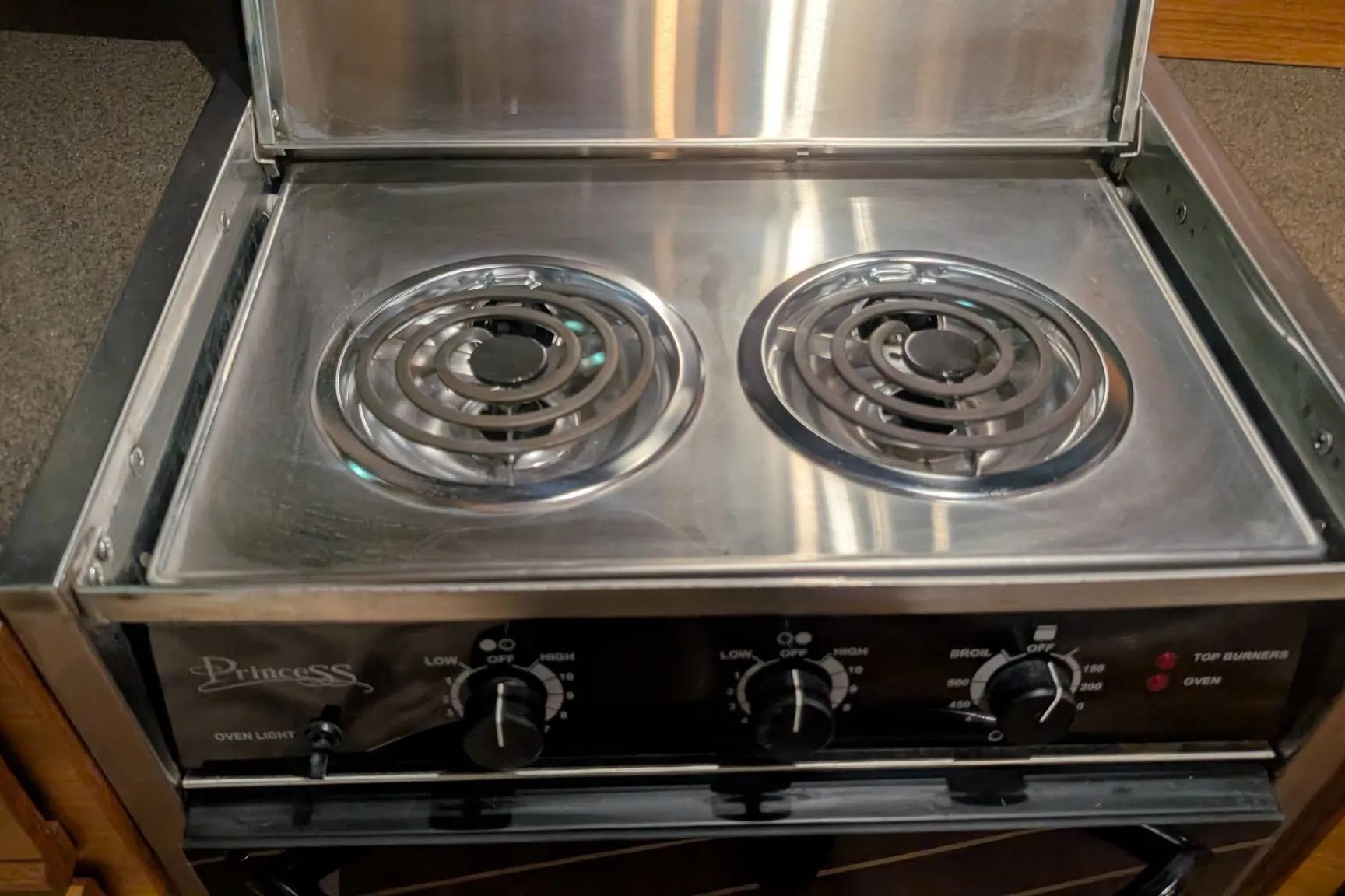 Stainless steel stove with dual burners in a 2015 Ranger Tugs R-29 S boat.