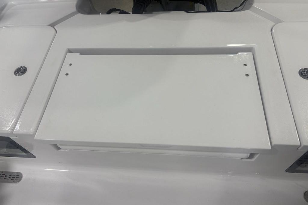 2026 Sportsman Masters 227 Bay Boat deck with storage compartment.