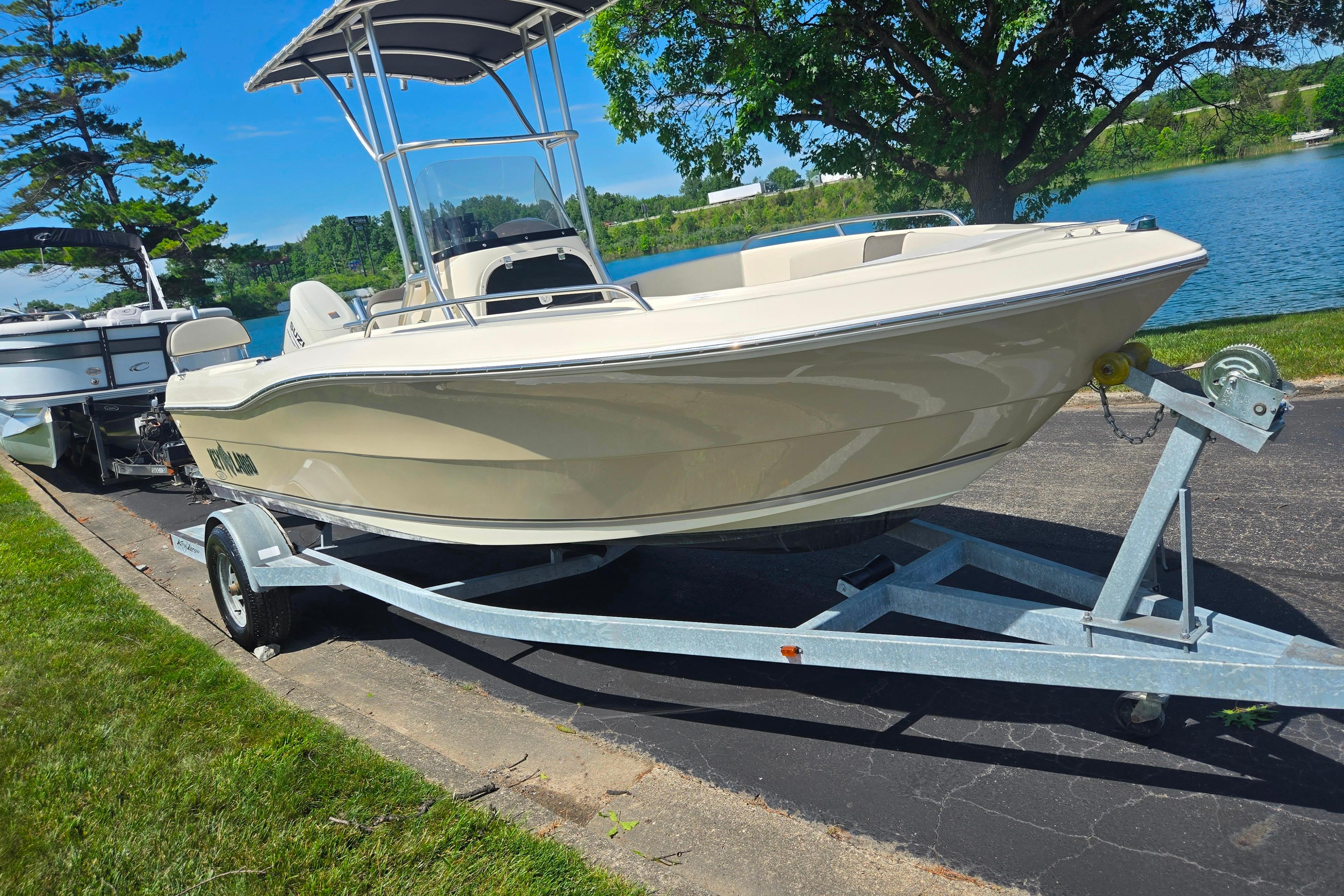 2016 Key Largo 2000CC boat on trailer by a scenic lake.