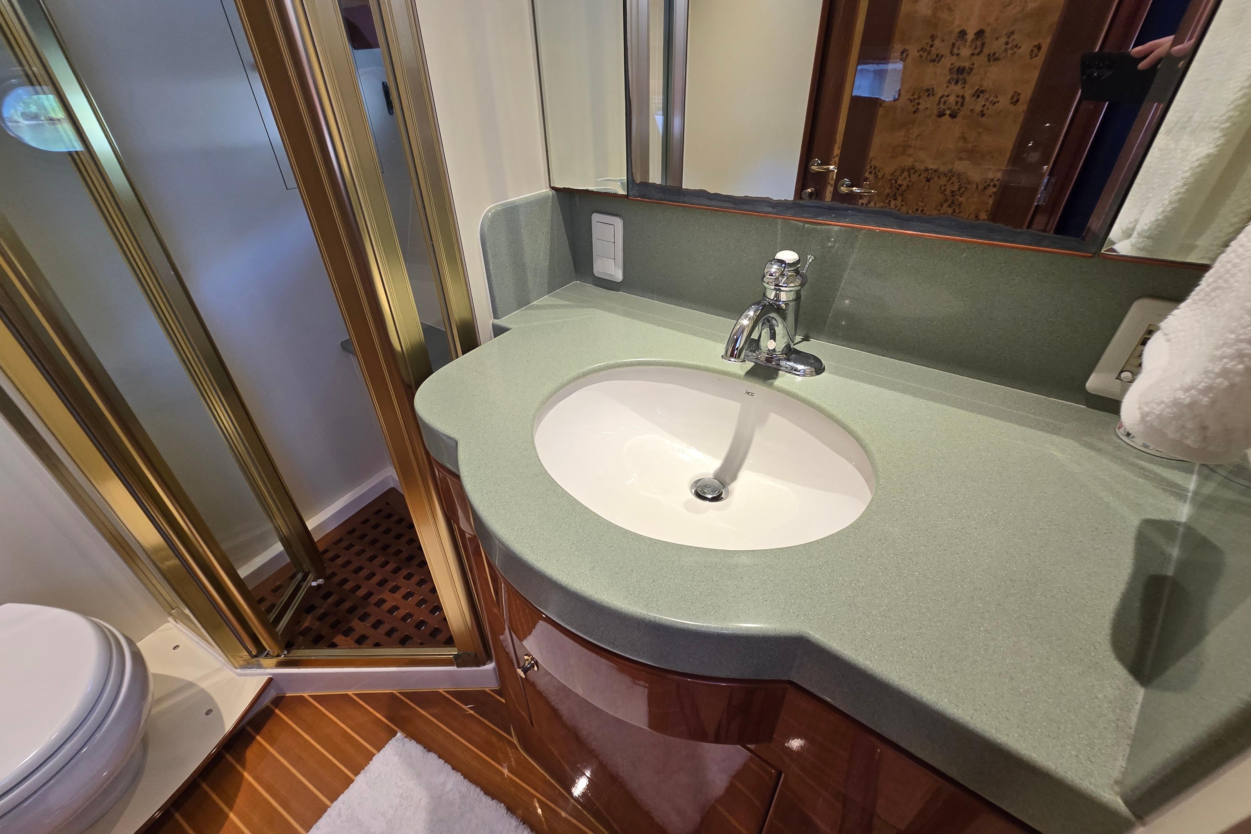 Luxurious bathroom in 2004 Grand Harbour 58 yacht with modern sink and shower.