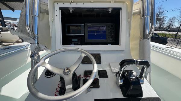 2005 Contender 36 Open boat helm with steering wheel, throttle, and navigation system.