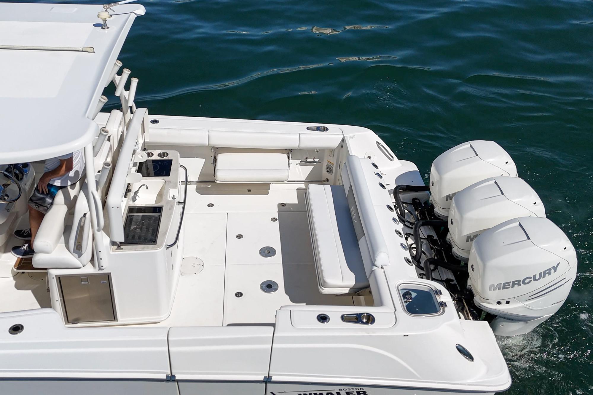 2015 Boston Whaler 370 Outrage boat with triple Mercury engines on water.