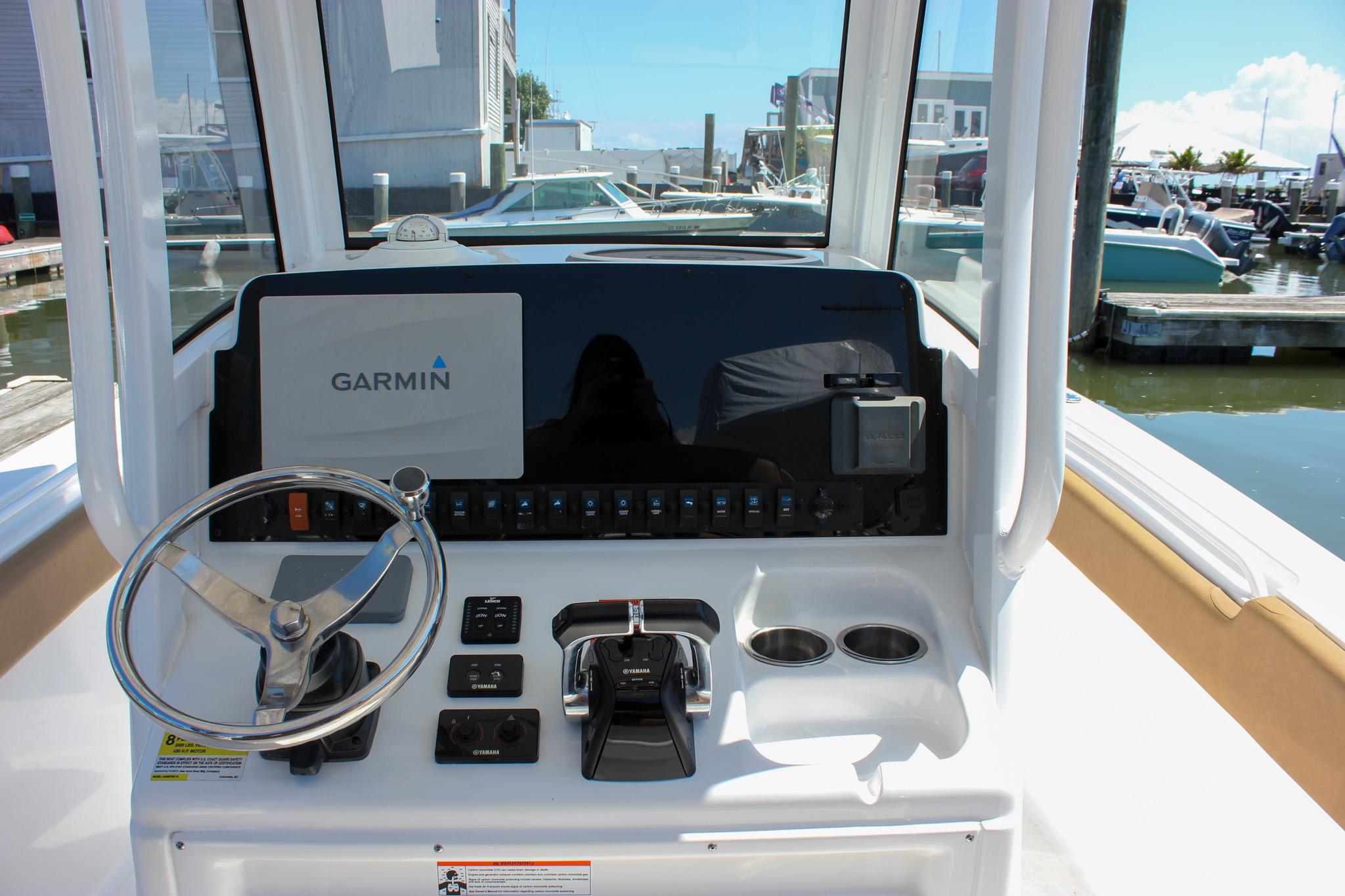 2020 Sea Hunt Gamefish 25 helm with Garmin display and controls at marina.