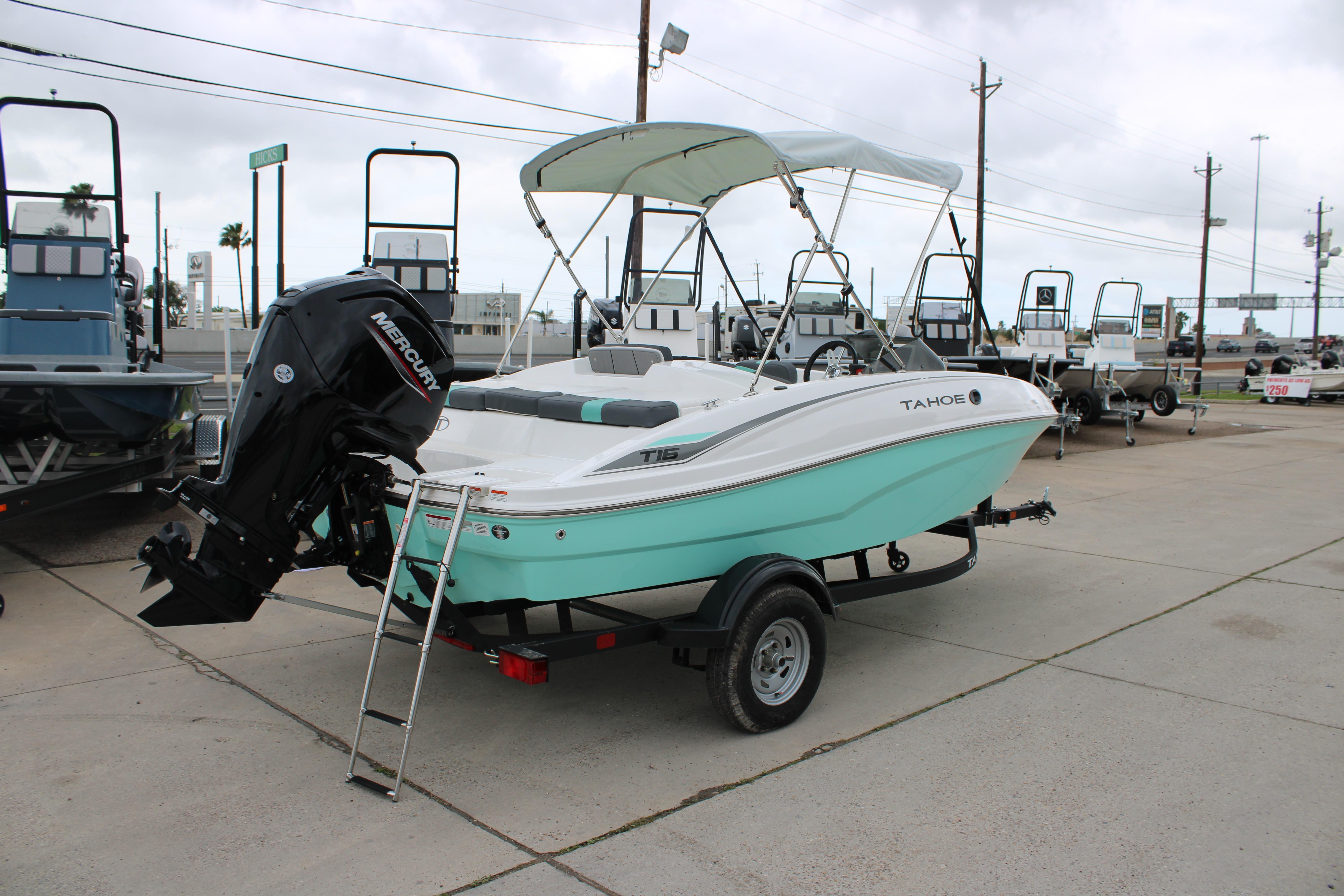2026 Tahoe T16 boat with Mercury engine, parked on a trailer in a marina.