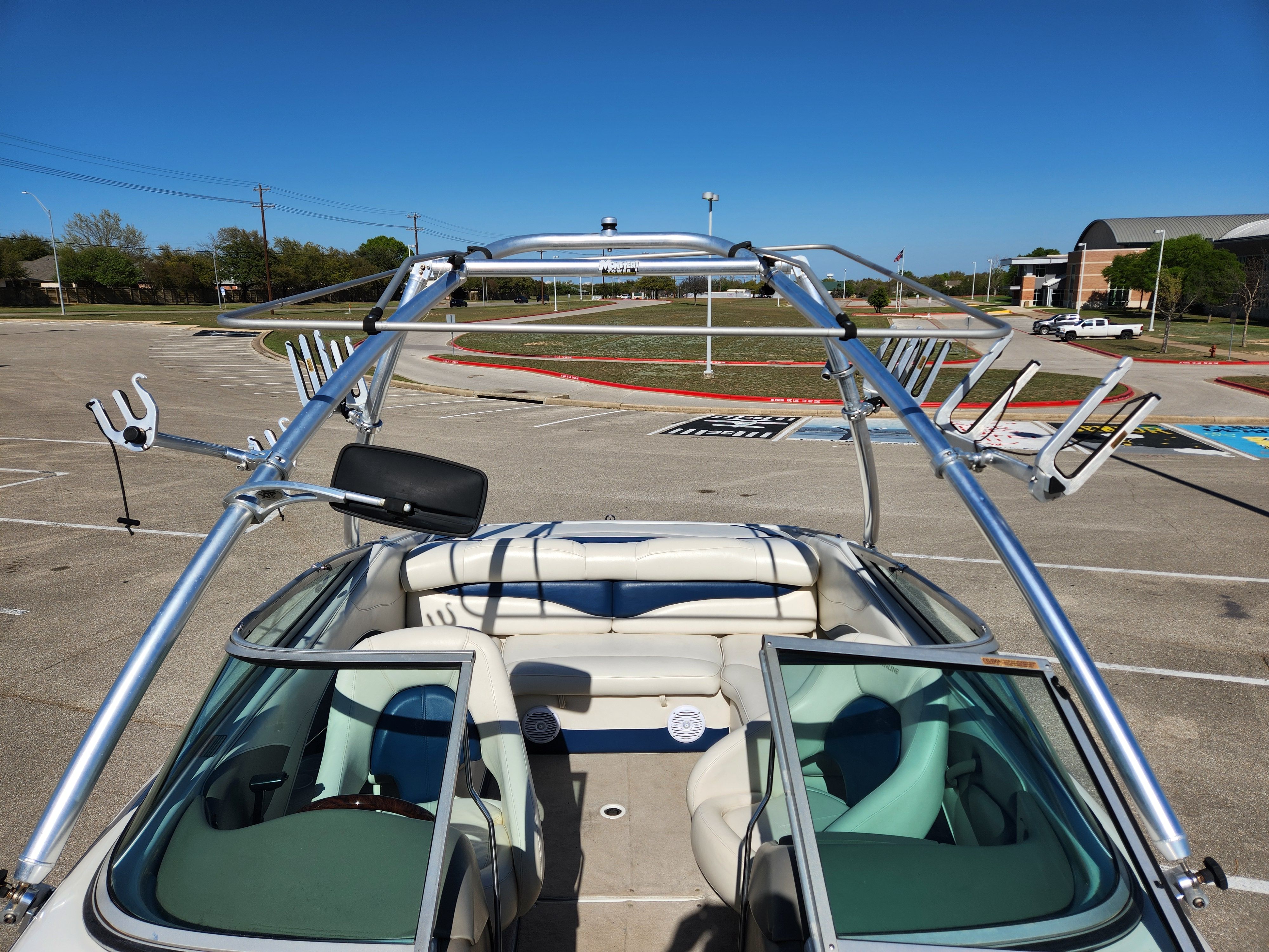 2003 Crownline 225 BR boat with wakeboard tower outdoors.
