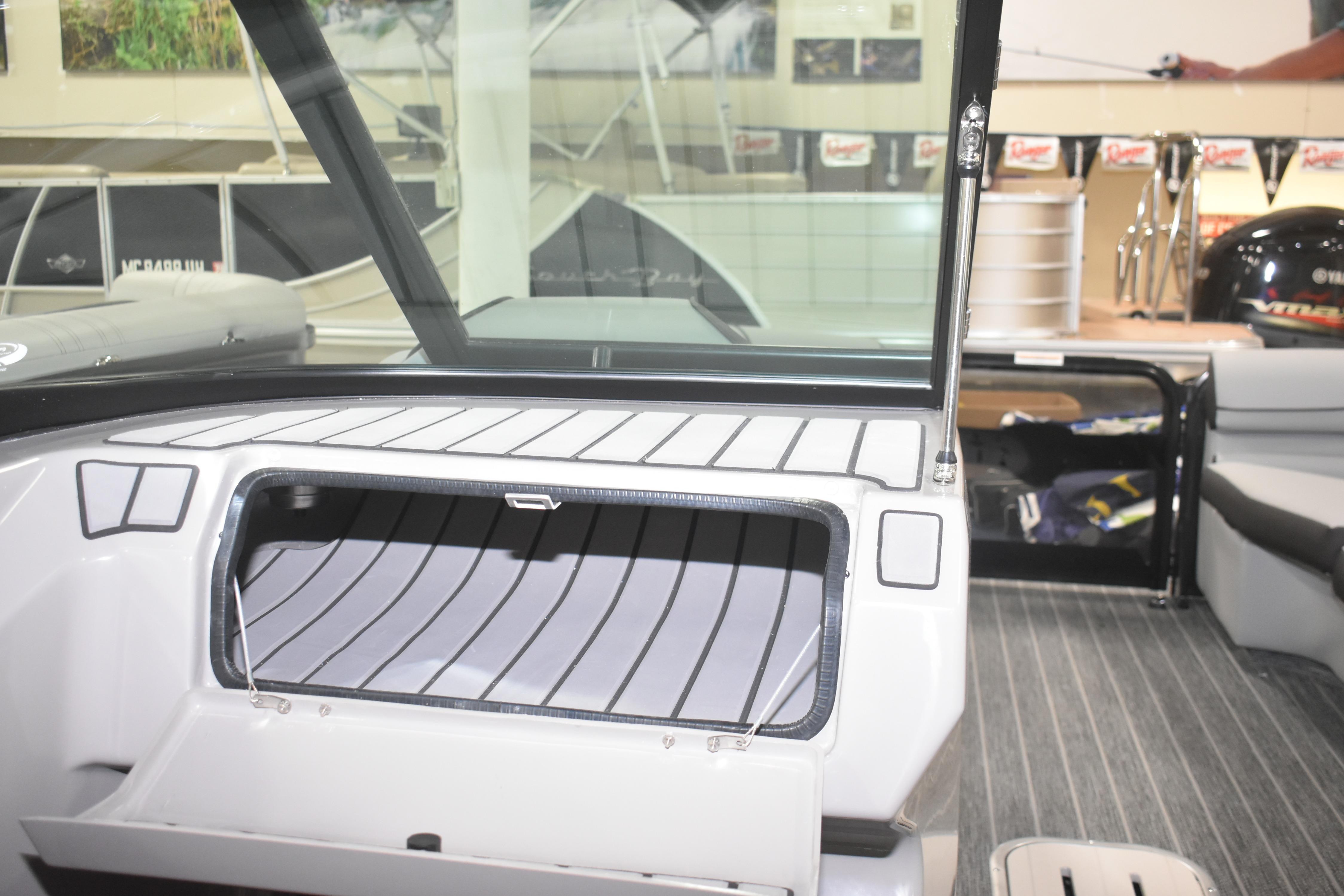 2026 Premier 250 Solaris Sport boat interior with open storage compartment.