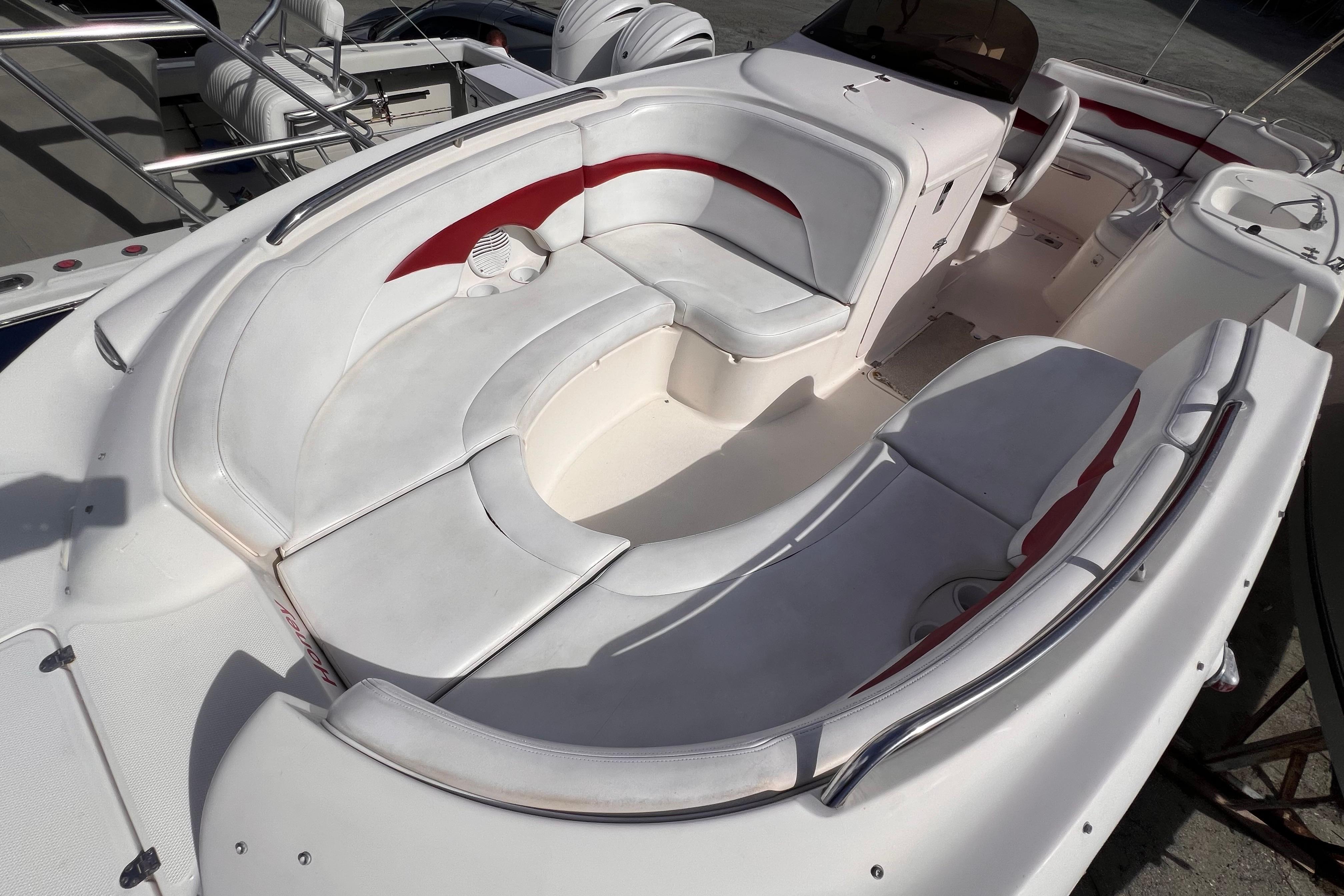 2002 Chaparral 232 Sunesta boat interior with white and red seating arrangement.