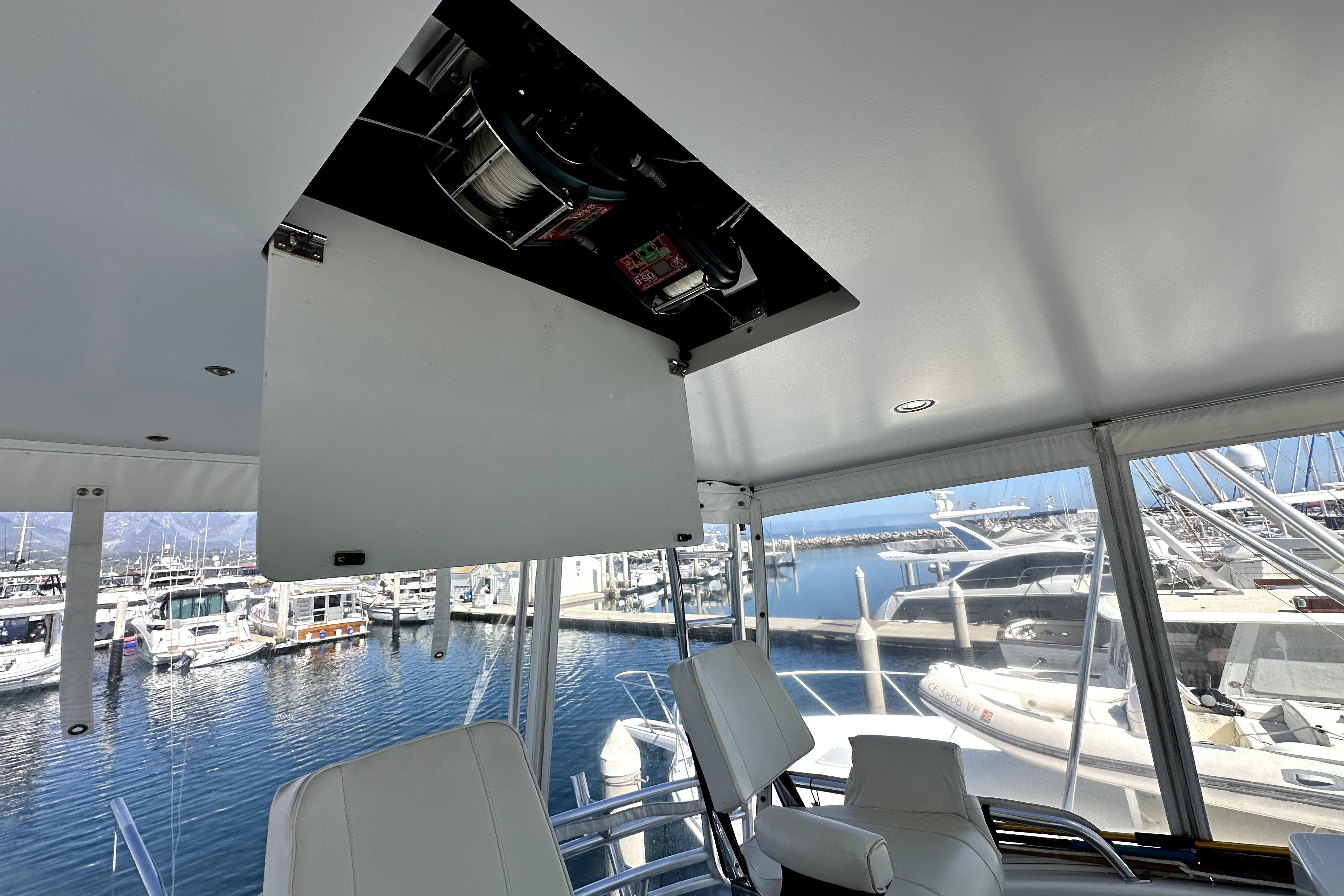 Interior view of 2003 Viking 61 Convertible yacht with marina backdrop.