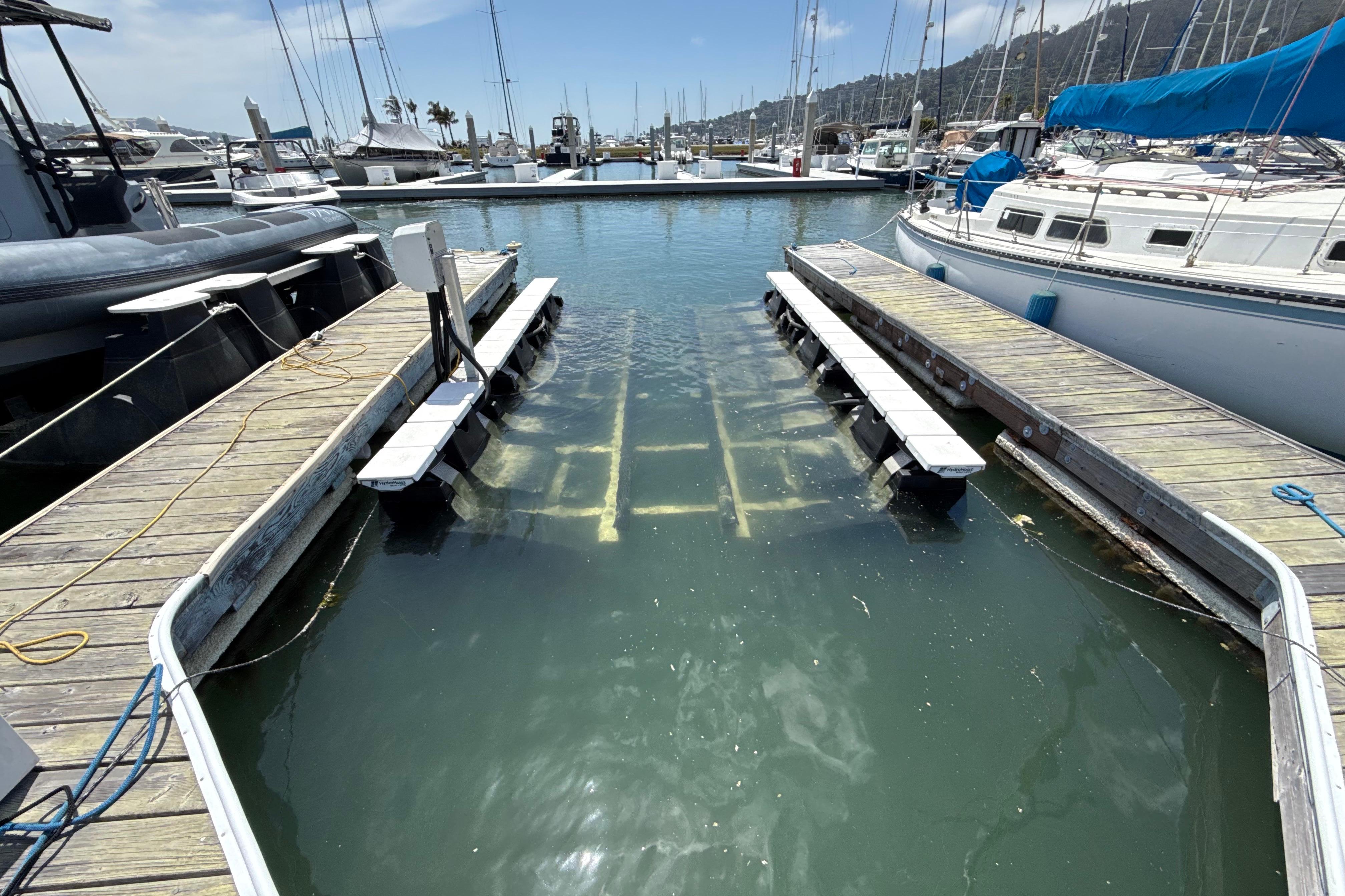 Marina with docks and boats, featuring a 2021 Bayliner VR5 Bowrider I/O.