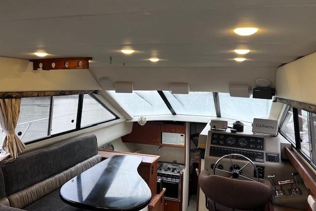 Interior of 1996 Bayliner 3388 Command Bridge Motoryacht with helm, seating, and navigation equipment.