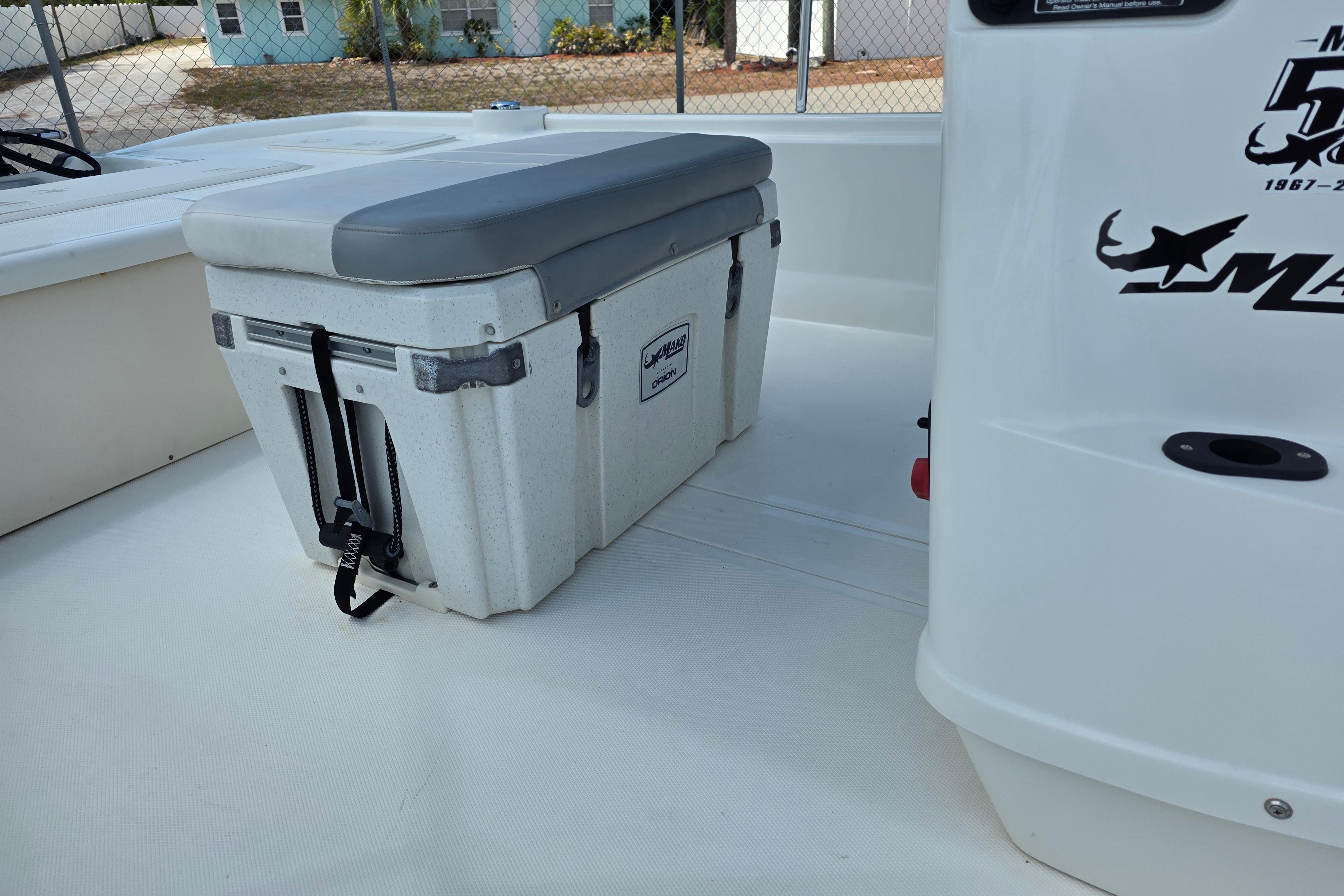 2018 Mako Pro Skiff 19 CC boat interior with cooler seat and logo.