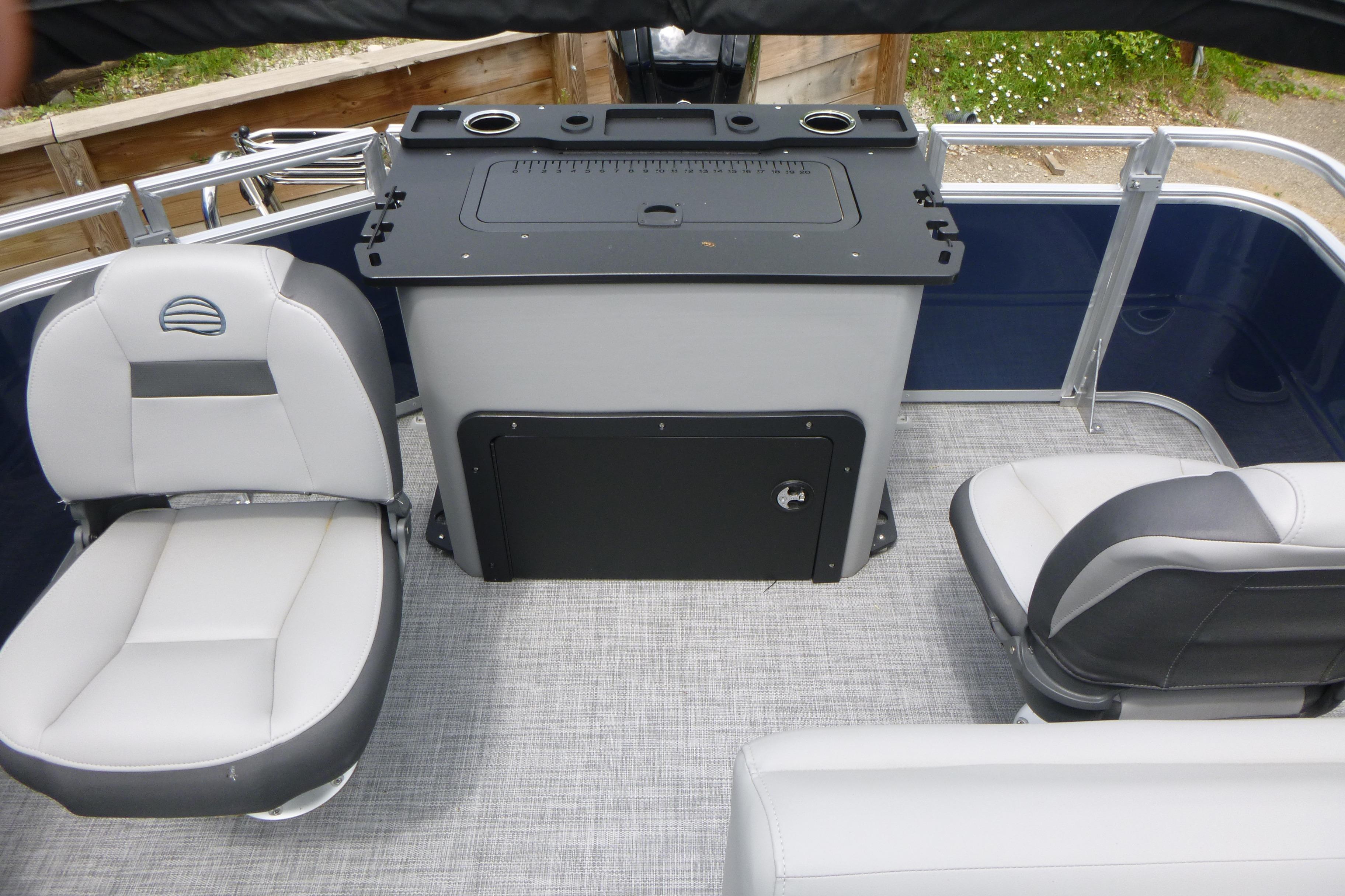 2026 Sun Tracker SportFish 22 DLX interior with seating and storage area.