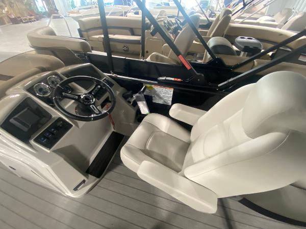 2024 Starcraft EXS 1 boat interior with steering wheel and captain's chair.