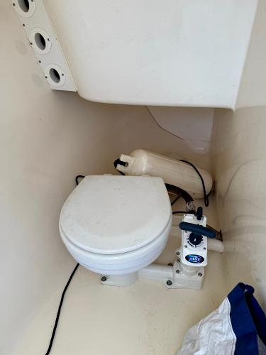 2016 Scout 245 Dorado boat toilet with marine equipment in compact space.