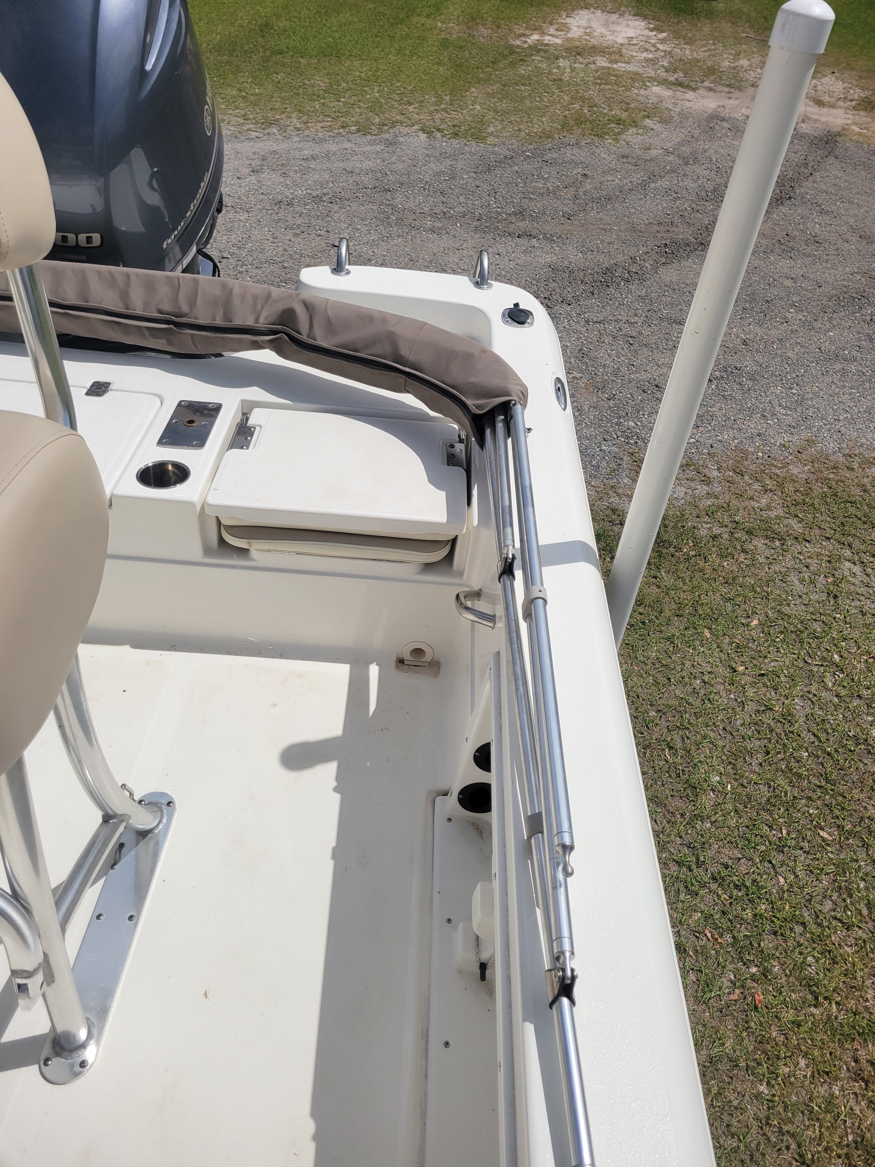 Part of a boat deck with seating and railing.