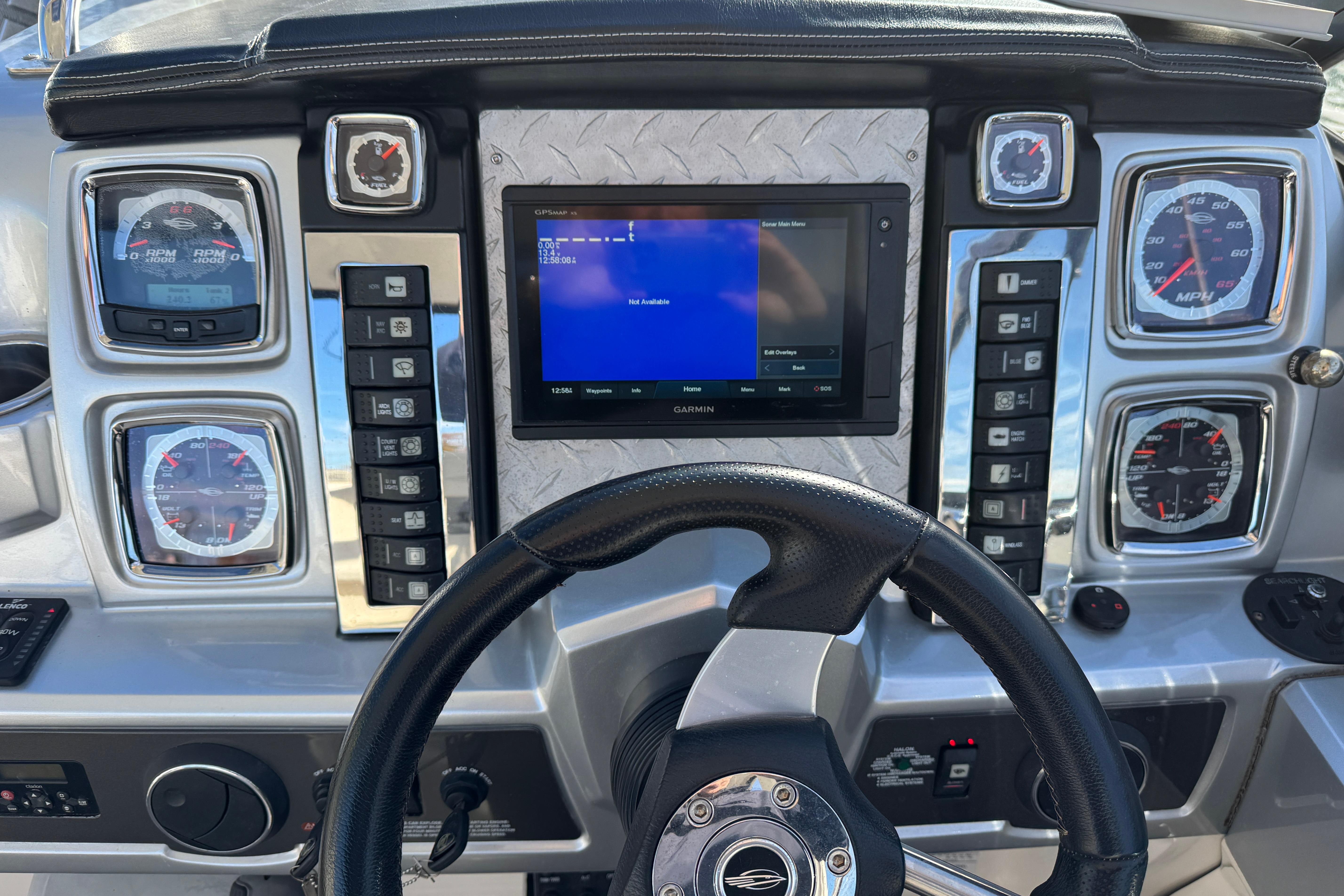 Dashboard of a 2012 Chaparral 327 SSX boat with gauges and Garmin display.