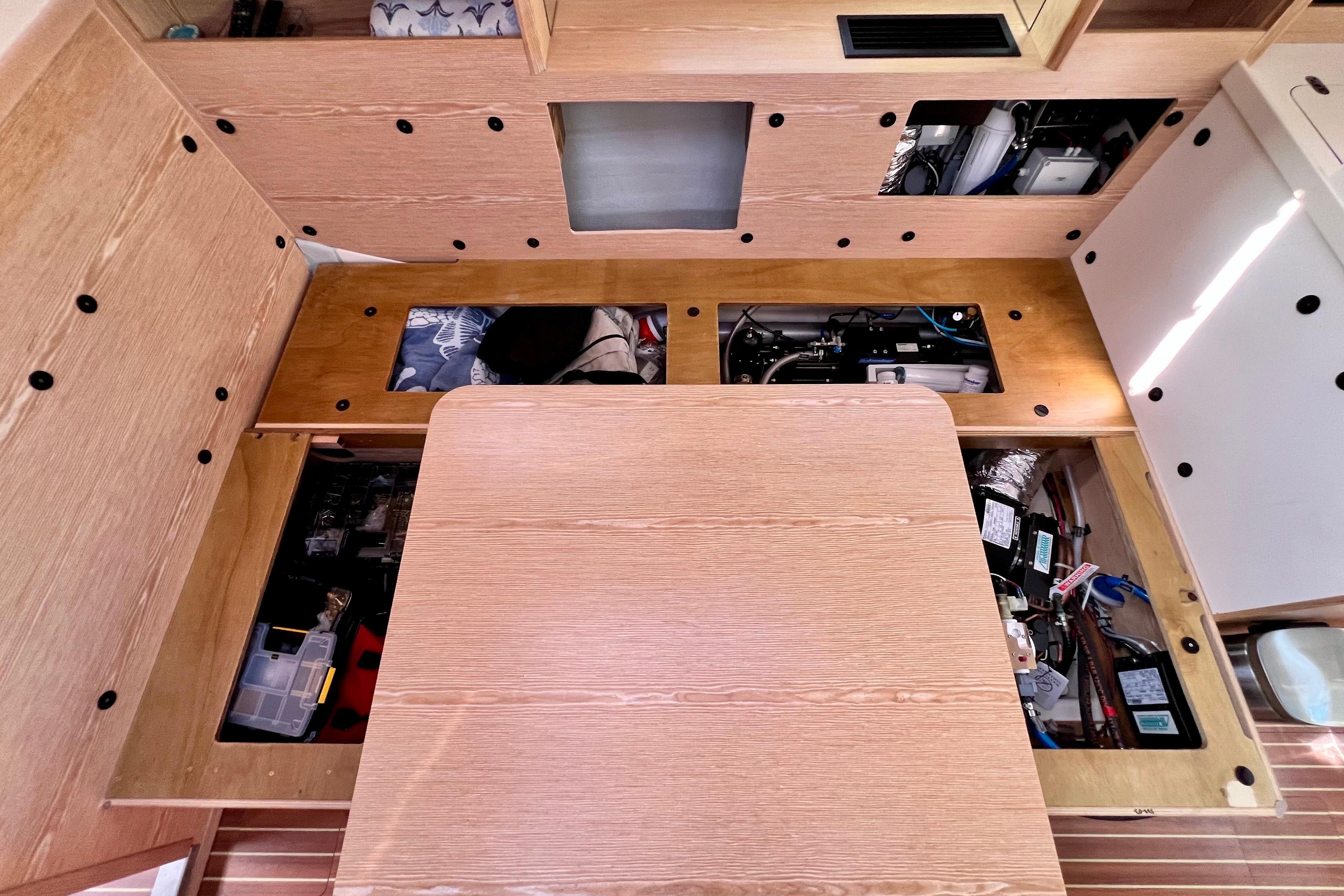 Interior view of a 2016 Hanse 455 yacht, showcasing under-seat storage compartments.