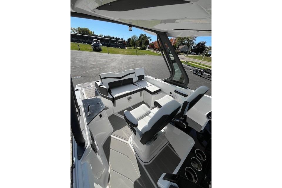2026 Monterey Elite 27 SD boat interior with seating and dashboard, parked outdoors.