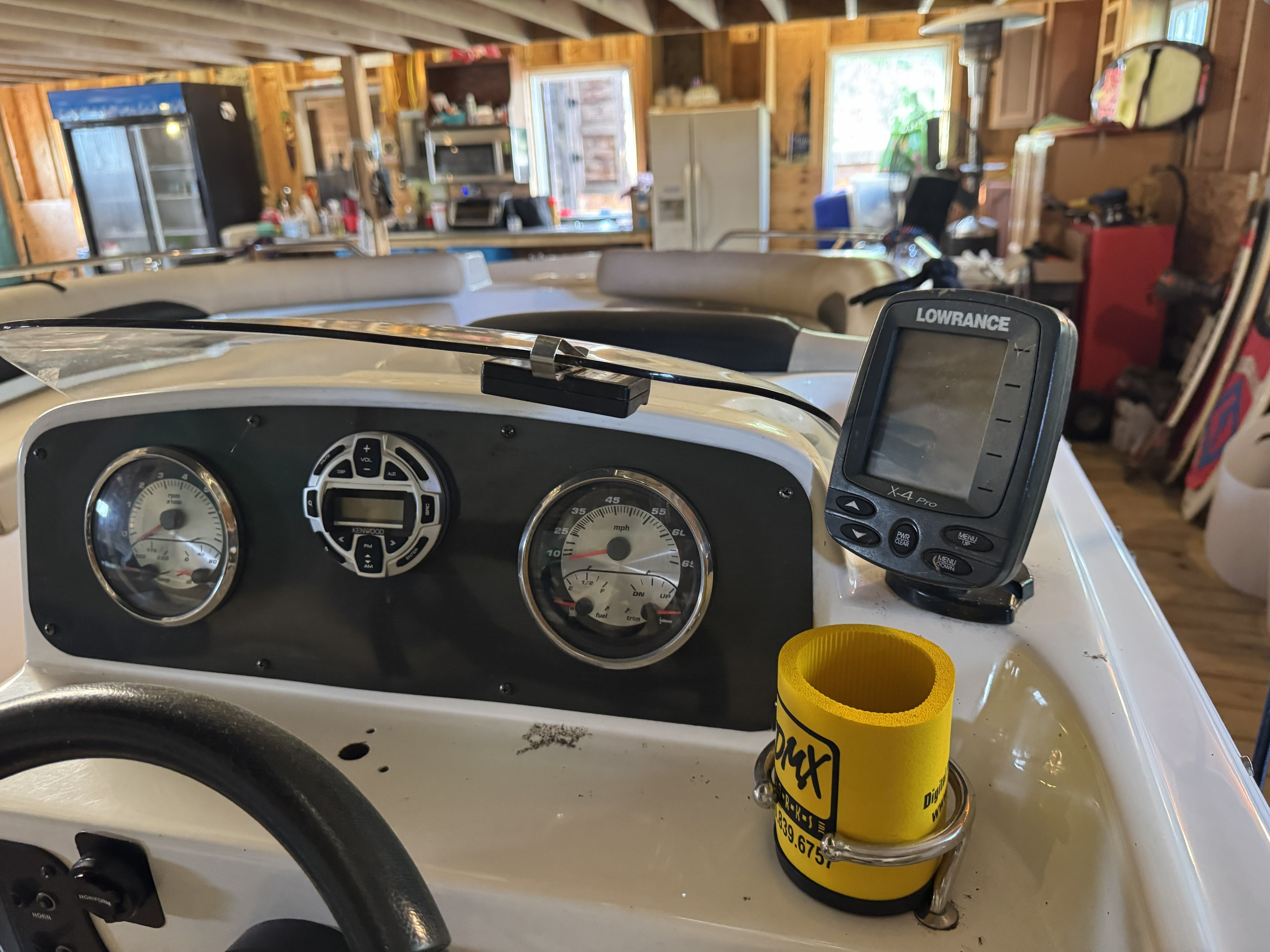 The dashboard of a 2014 Hurricane SS201 I/O boat with instruments and a Lowrance device.
