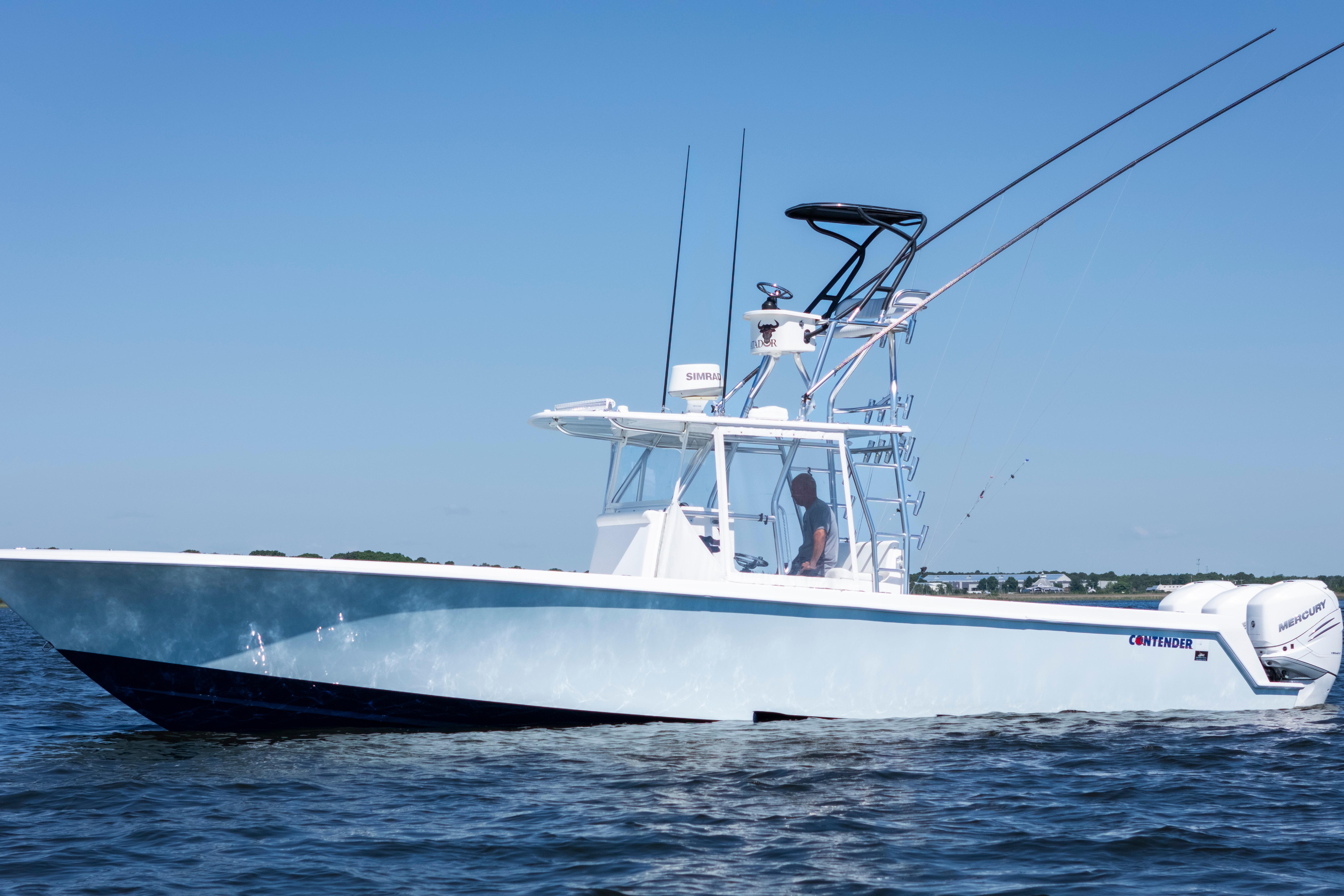 2015 Contender 39 ST boat on water, clear sky, equipped with fishing rods.