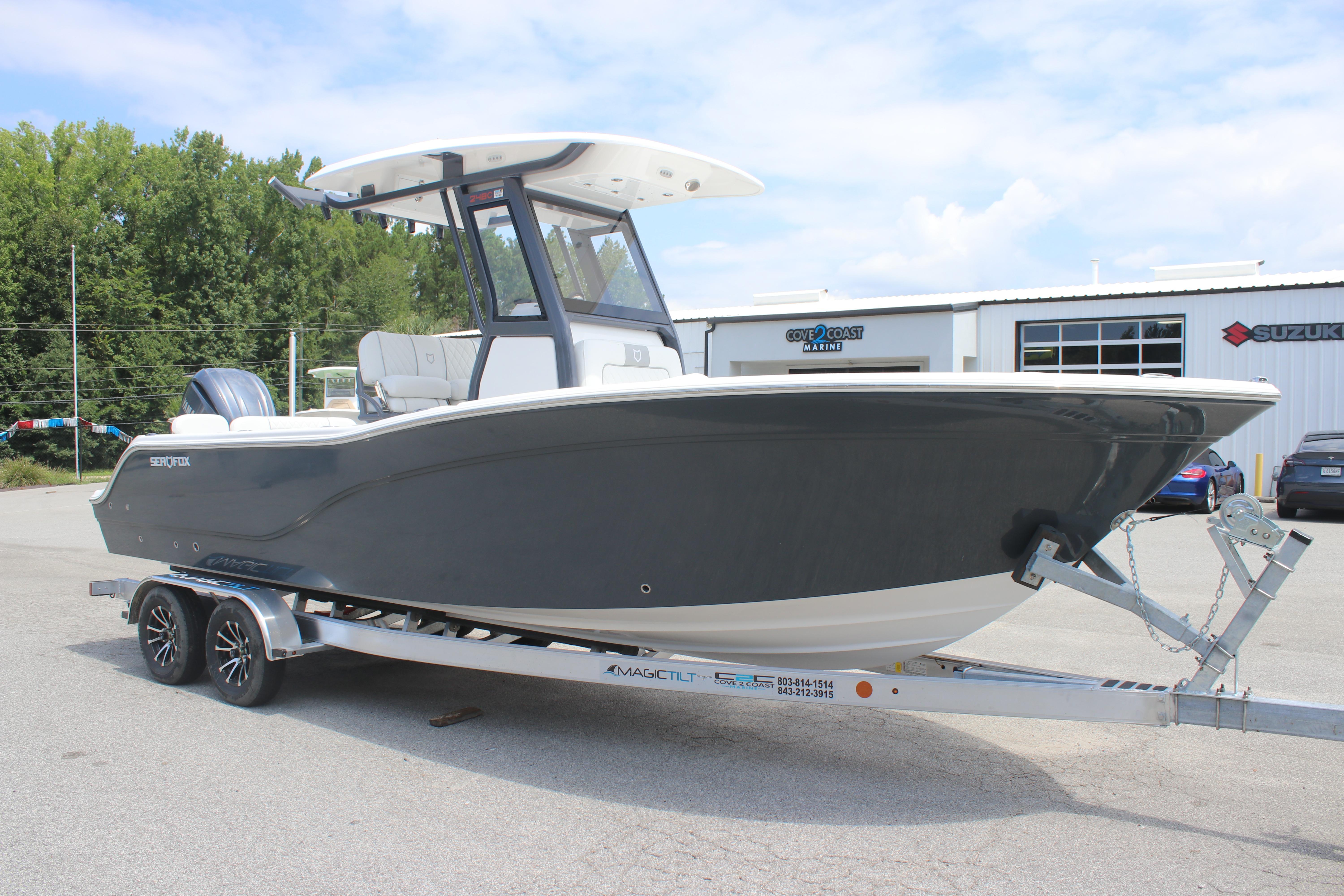 2026 Sea Fox 248 Commander boat on trailer, parked outdoors near marine dealership.