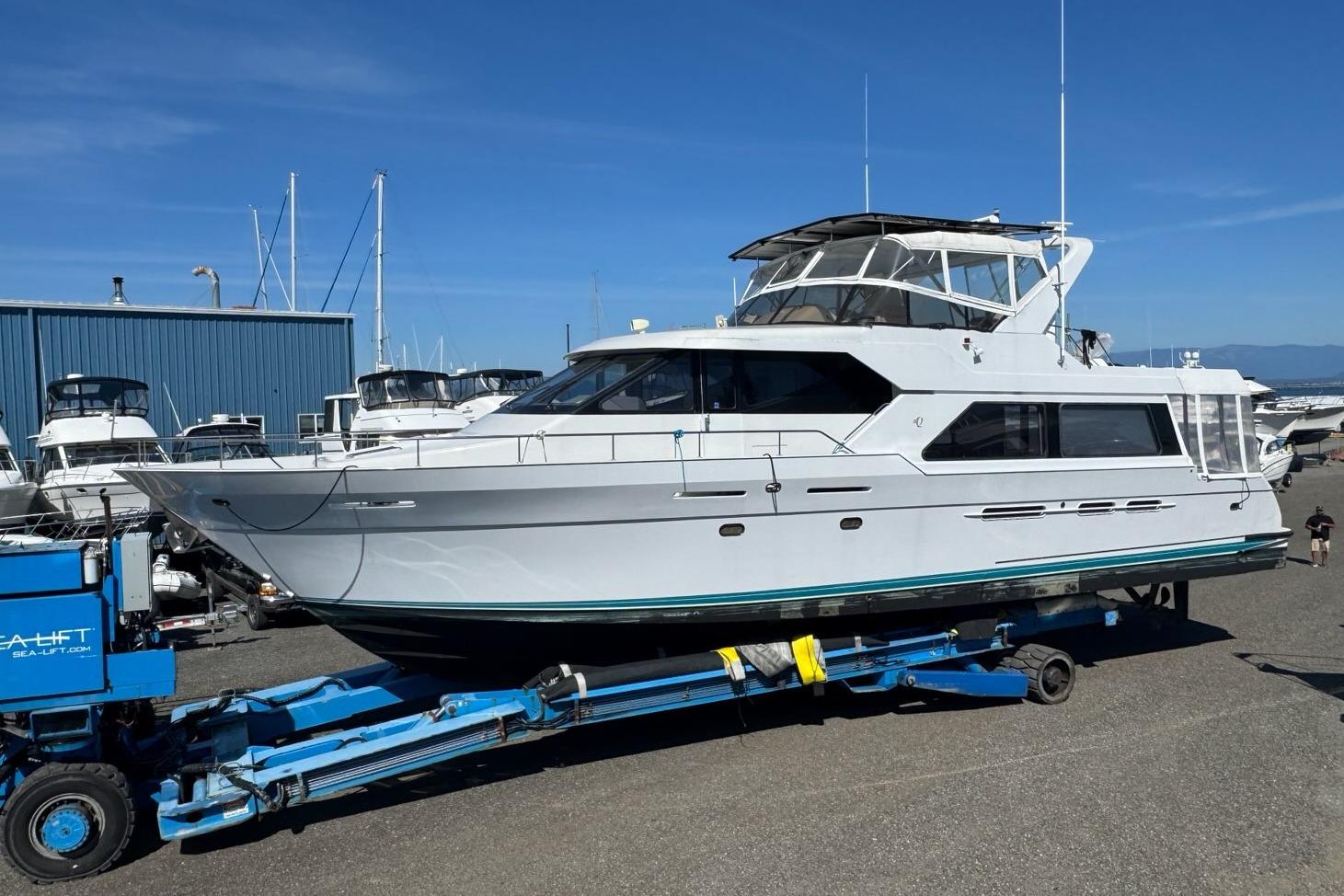 1995 Queenship 62 Pilothouse Motor Yacht on trailer at marina.