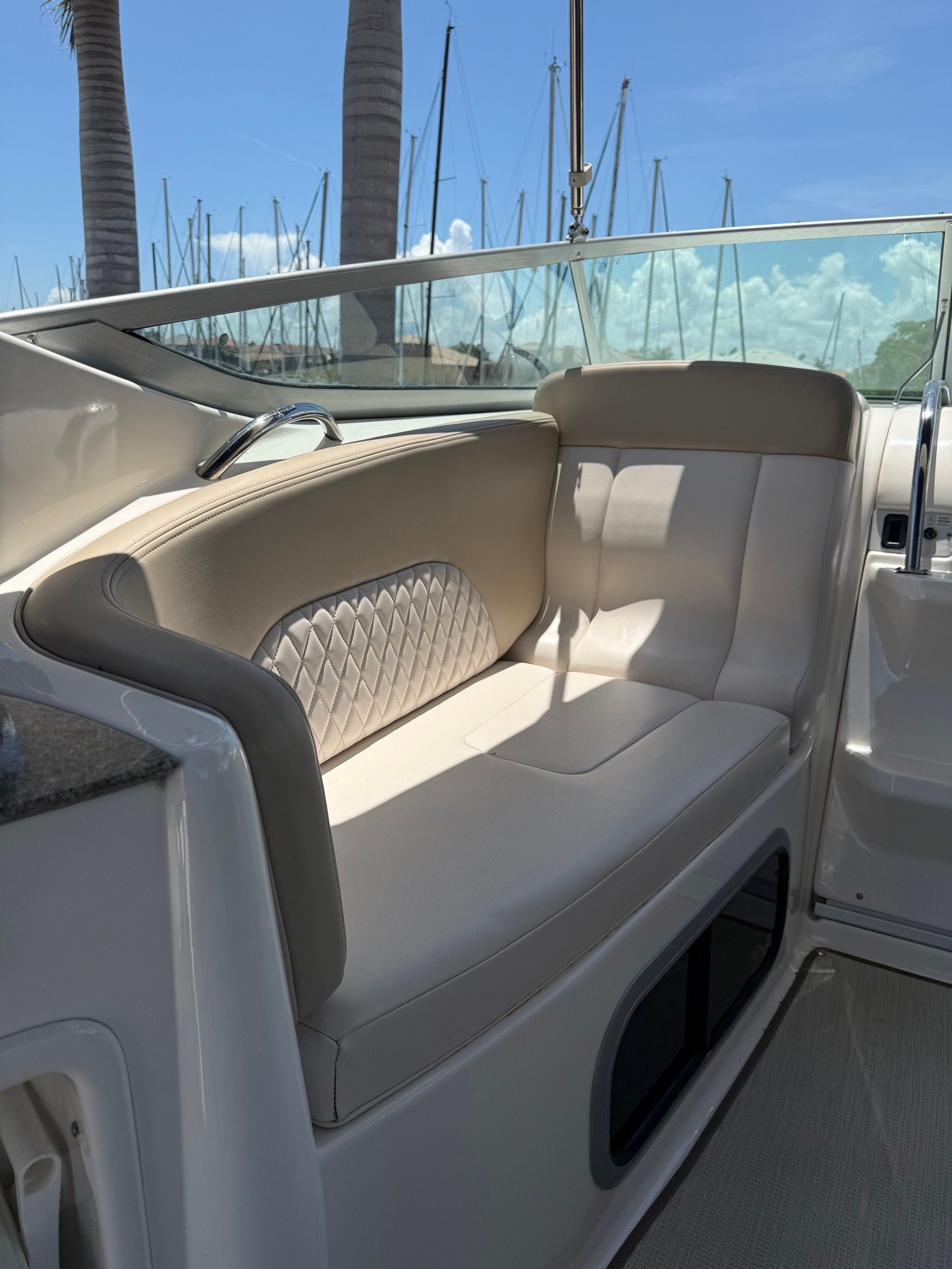 Interior of a 2018 Chaparral 270 Signature boat with beige seating.