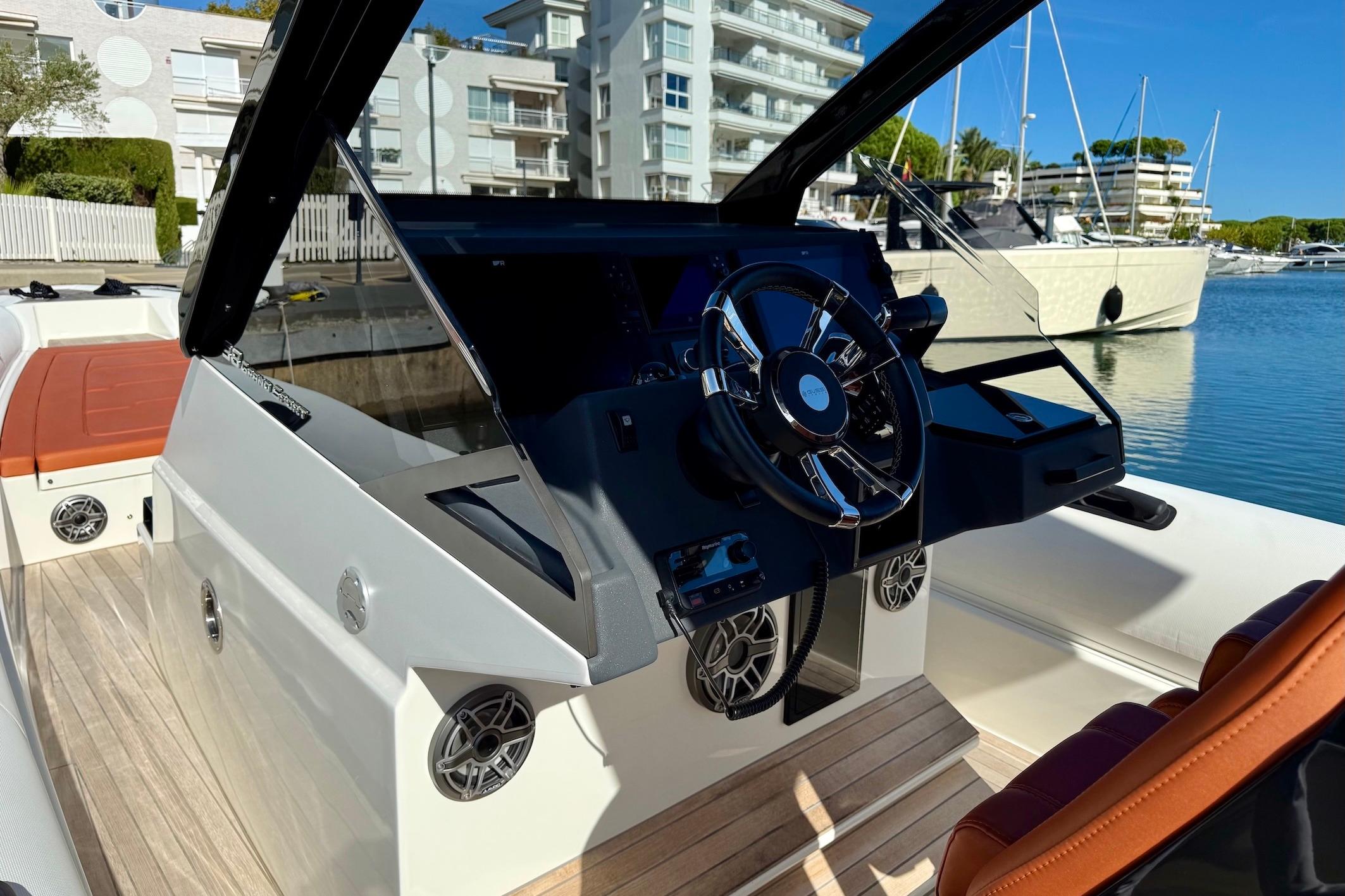 2025 Technohull 38 Grand Sport boat interior with sleek steering wheel and modern dashboard.