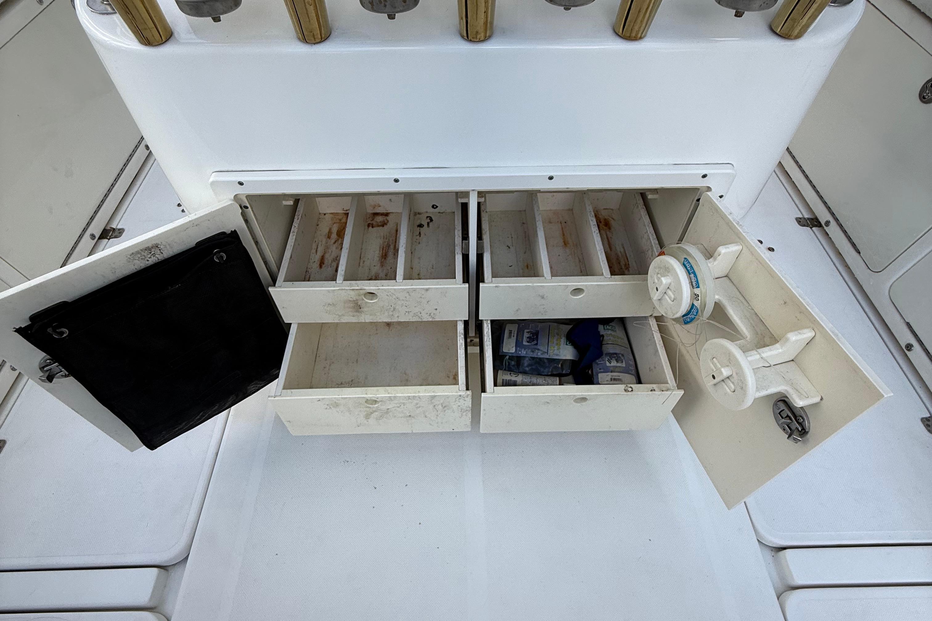Open storage compartments on a 2008 Century 2901 Center Console boat.