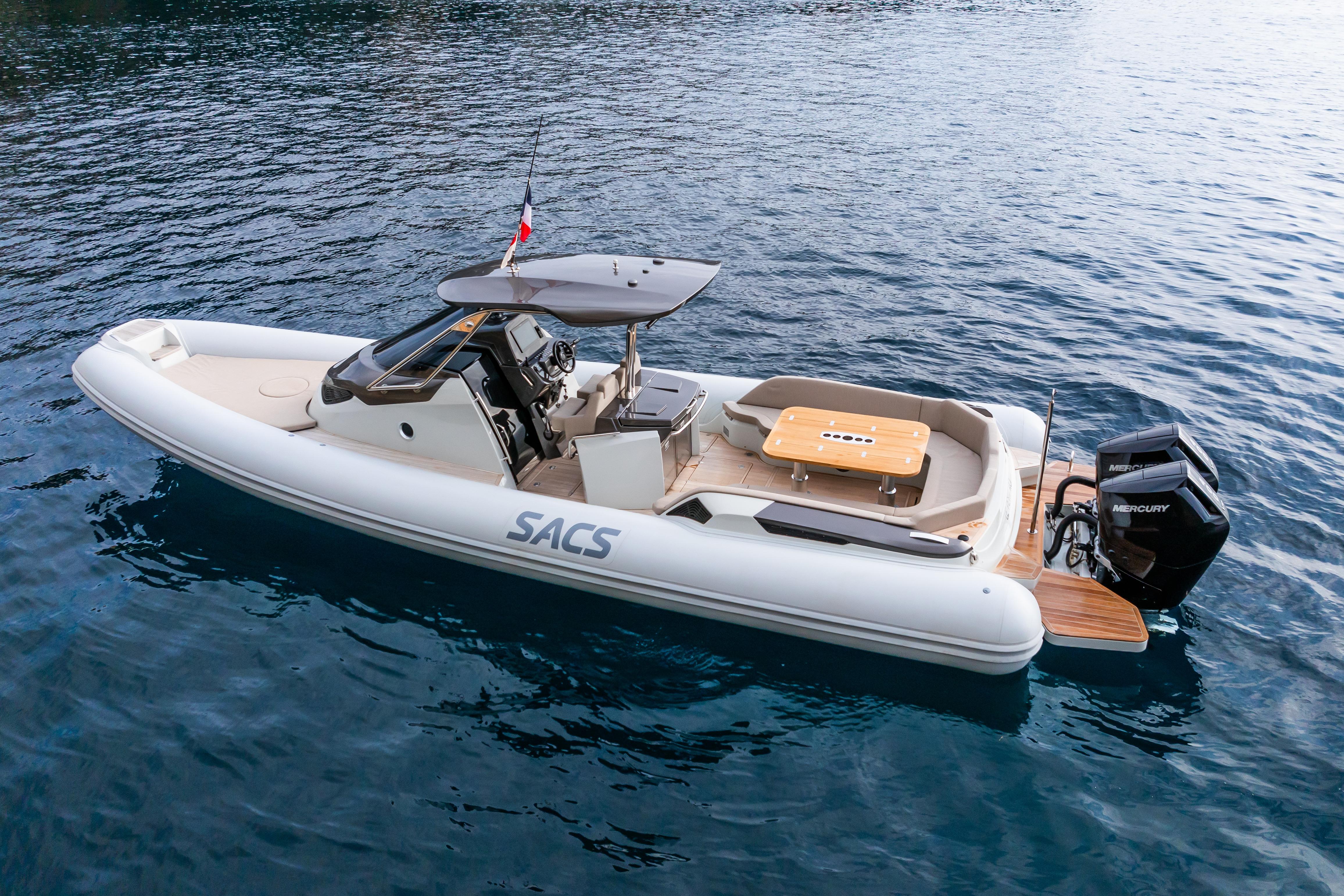 2025 SACS STRIDER 11 OPEN BACK boat on calm blue water.