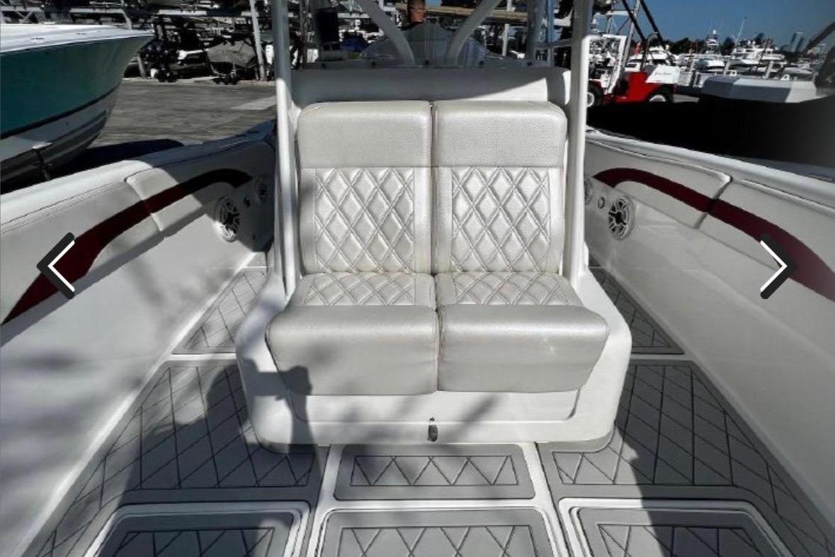 Luxury seating on a 2015 Deep Impact 33 boat, featuring diamond-pattern upholstery.